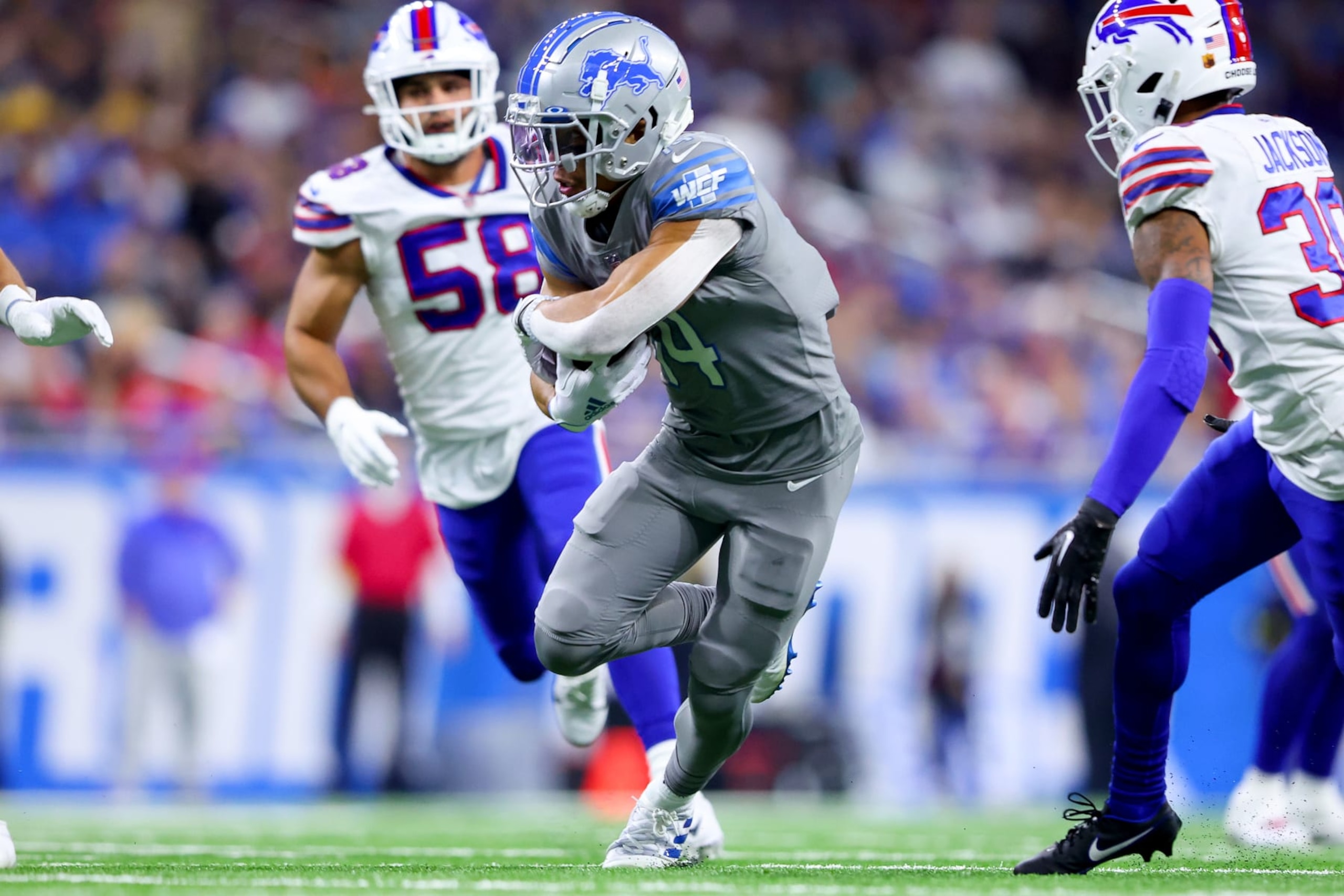 DETROIT, MICHIGAN - NOVEMBER 24: Amon-Ra St. Brown #14 of the Detroit Lions carries the ball against the Buffalo Bills during the first quarter at Ford Field on November 24, 2022 in Detroit, Michigan. (Photo by Rey Del Rio/Getty Images) DETROIT, MICHIGAN - NOVEMBER 24: Amon-Ra St. Brown #14 of the Detroit Lions carries the ball against the Buffalo Bills during the first quarter at Ford Field on November 24, 2022 in Detroit, Michigan. (Photo by Rey Del Rio/Getty Images)