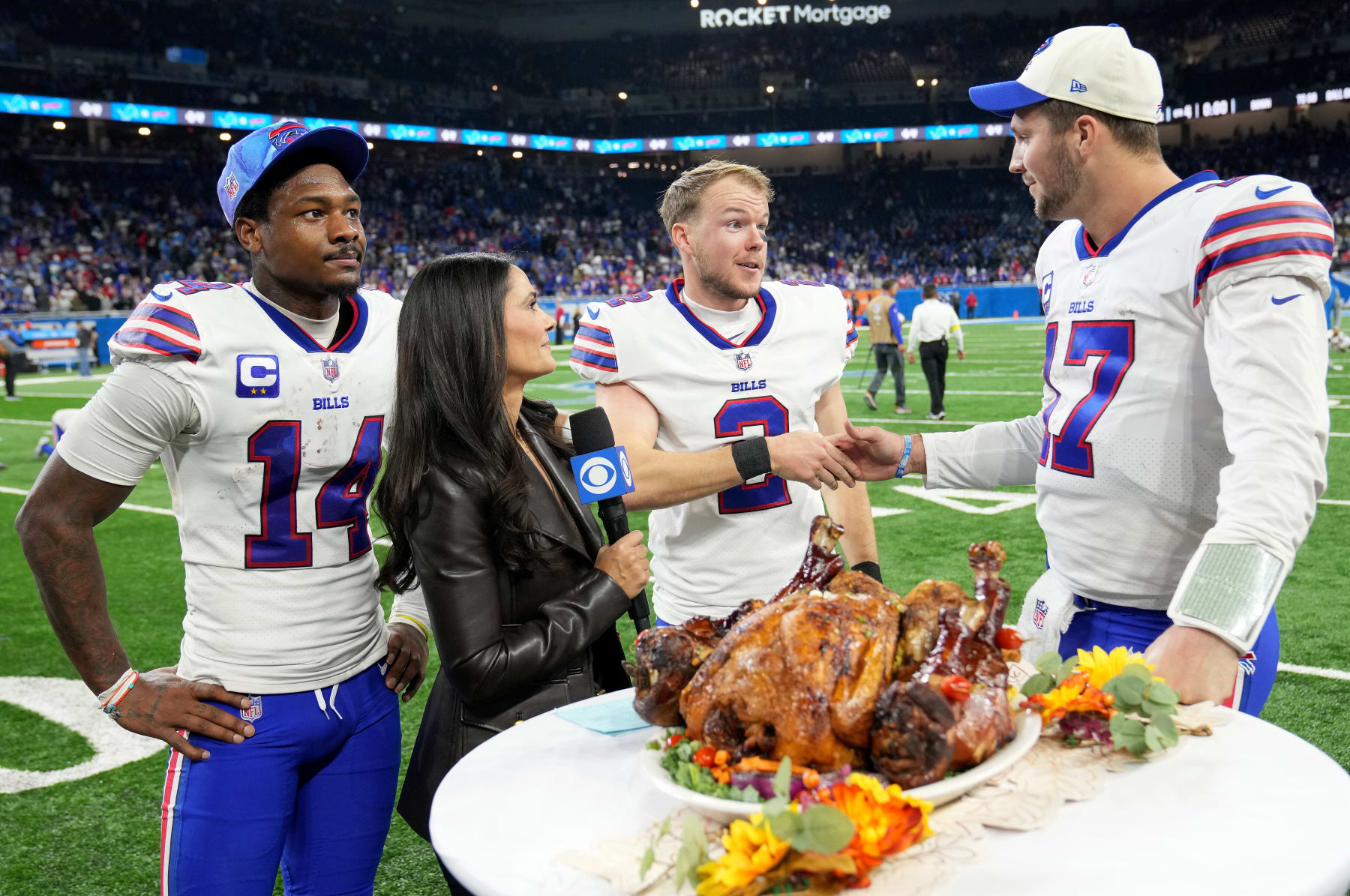 DETROIT, MICHIGAN - NOVEMBER 24: Stefon Diggs #14, Tyler Bass #2 and Josh Allen #17 of the Buffalo Bills celebrate on the field after defeating the Detroit Lions at Ford Field on November 24, 2022 in Detroit, Michigan. (Photo by Nic Antaya/Getty Images)