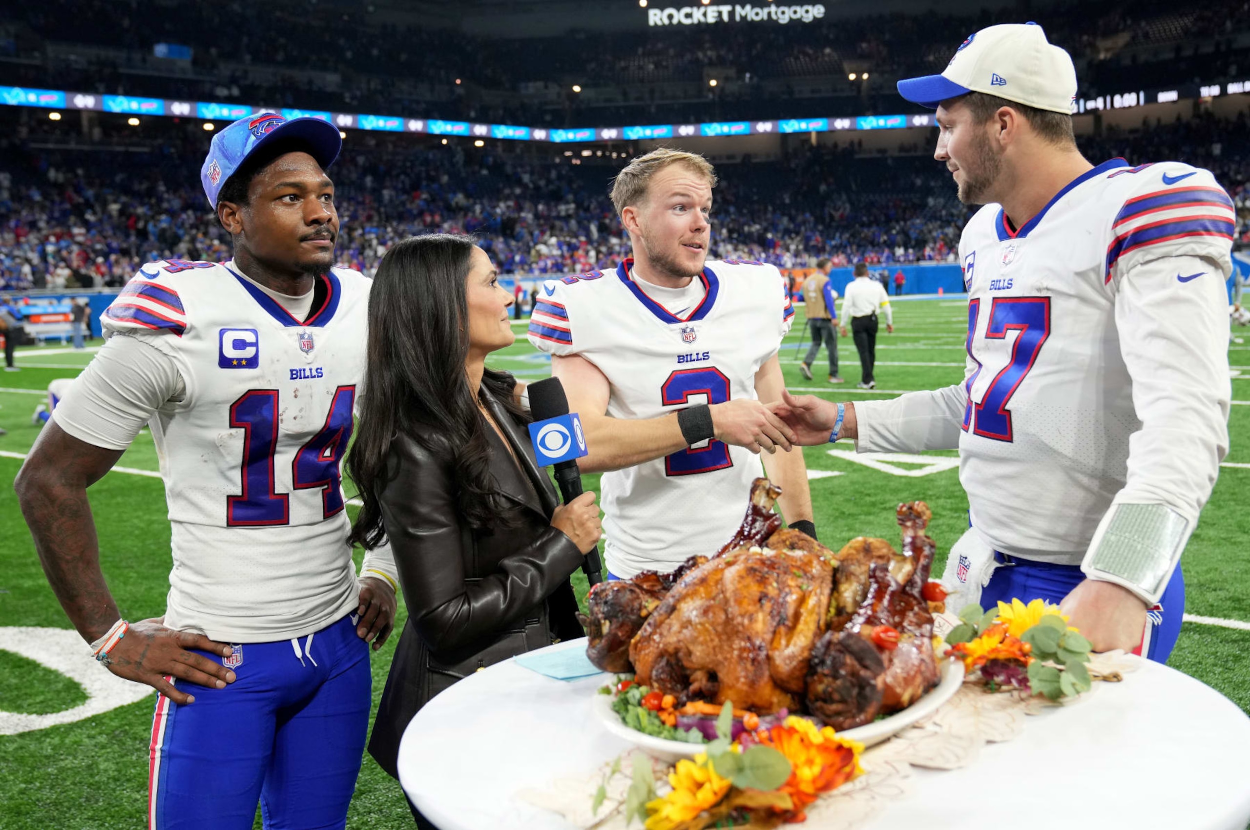 DETROIT, MICHIGAN - NOVEMBER 24: Stefon Diggs #14, Tyler Bass #2 and Josh Allen #17 of the Buffalo Bills celebrate on the field after defeating the Detroit Lions at Ford Field on November 24, 2022 in Detroit, Michigan. (Photo by Nic Antaya/Getty Images) DETROIT, MICHIGAN - NOVEMBER 24: Stefon Diggs #14, Tyler Bass #2 and Josh Allen #17 of the Buffalo Bills celebrate on the field after defeating the Detroit Lions at Ford Field on November 24, 2022 in Detroit, Michigan. (Photo by Nic Antaya/Getty Images)