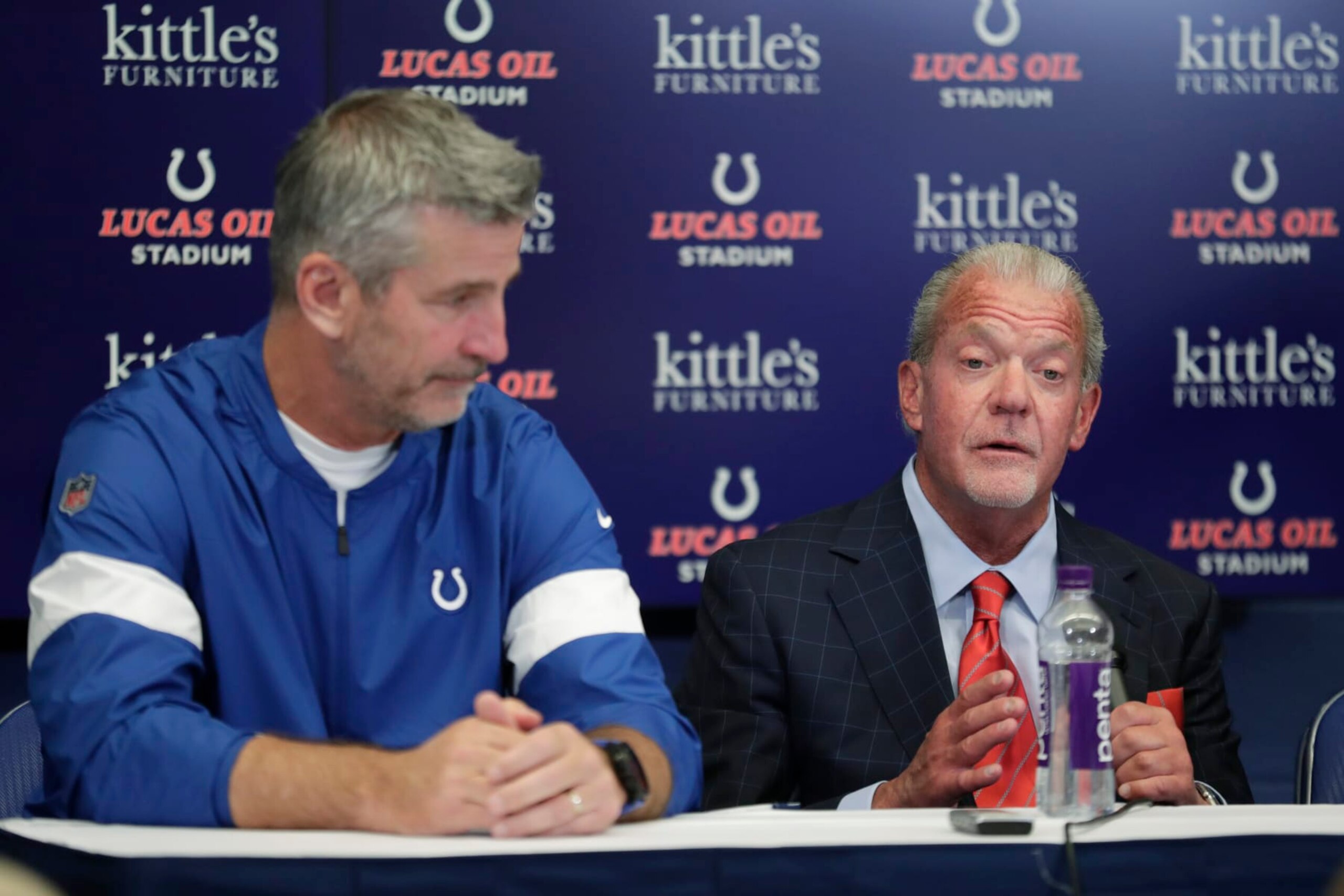 Indianapolis Colts coach Frank Reich listens as team owner Jim Irsay speaks following a news conference after the Colts' NFL preseason football game against the Chicago Bears, Saturday, Aug. 24, 2019, in Indianapolis. Colts quarterback Andrew Luck announced that he his retiring at age 29. (AP Photo/Michael Conroy)