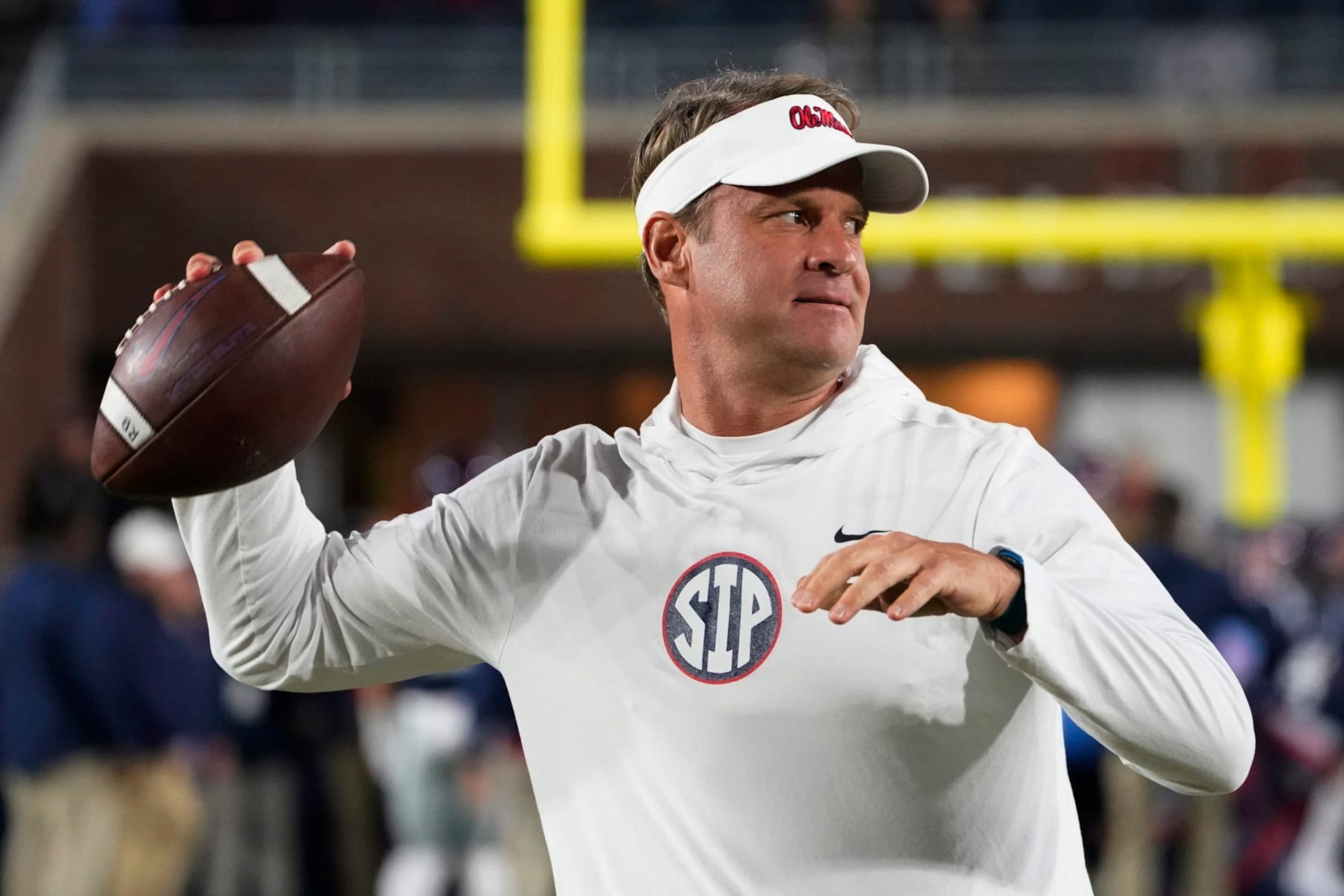 Mississippi coach Lane Kiffin passes the ball to a player during warmups for the team's NCAA college football game against Mississippi State in Oxford, Miss., Thursday, Nov. 24, 2022. (AP Photo/Rogelio V. Solis) Mississippi coach Lane Kiffin passes the ball to a player during warmups for the team's NCAA college football game against Mississippi State in Oxford, Miss., Thursday, Nov. 24, 2022. (AP Photo/Rogelio V. Solis)