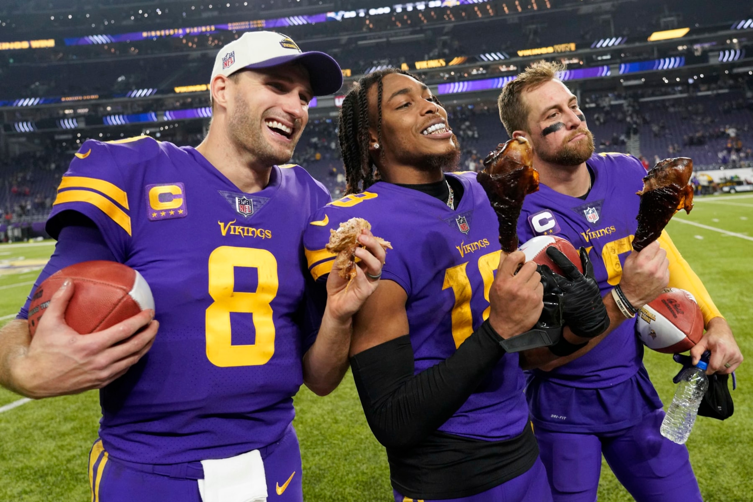 MINNEAPOLIS, MINNESOTA - NOVEMBER 24: Kirk Cousins #8, Justin Jefferson #18 and Adam Thielen #19 of the Minnesota Vikings eat turkey legs on the field after defeating the New England Patriots at U.S. Bank Stadium on November 24, 2022 in Minneapolis, Minnesota. (Photo by David Berding/Getty Images) MINNEAPOLIS, MINNESOTA - NOVEMBER 24: Kirk Cousins #8, Justin Jefferson #18 and Adam Thielen #19 of the Minnesota Vikings eat turkey legs on the field after defeating the New England Patriots at U.S. Bank Stadium on November 24, 2022 in Minneapolis, Minnesota. (Photo by David Berding/Getty Images)