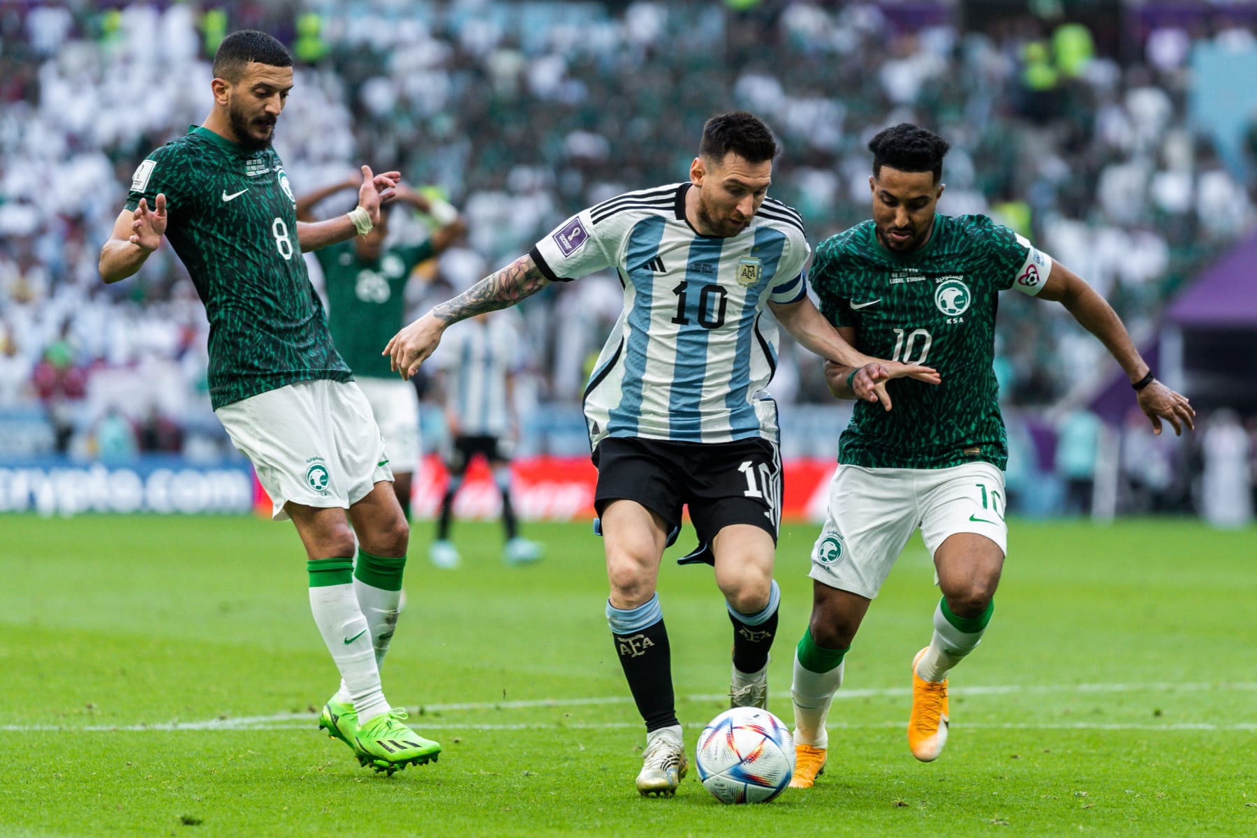 LUSAIL, QATAR - NOVEMBER 22: Argentina forward Leonel Messi fights of the challenges of two Saudi players during the second half of the 2022 FIFA World Cup group C match between Argentina and Saudi Arabia at Lusail Iconic Stadium in Lusail, Qatar. (Photo by Richard Gordon/Icon Sportswire via Getty Images)