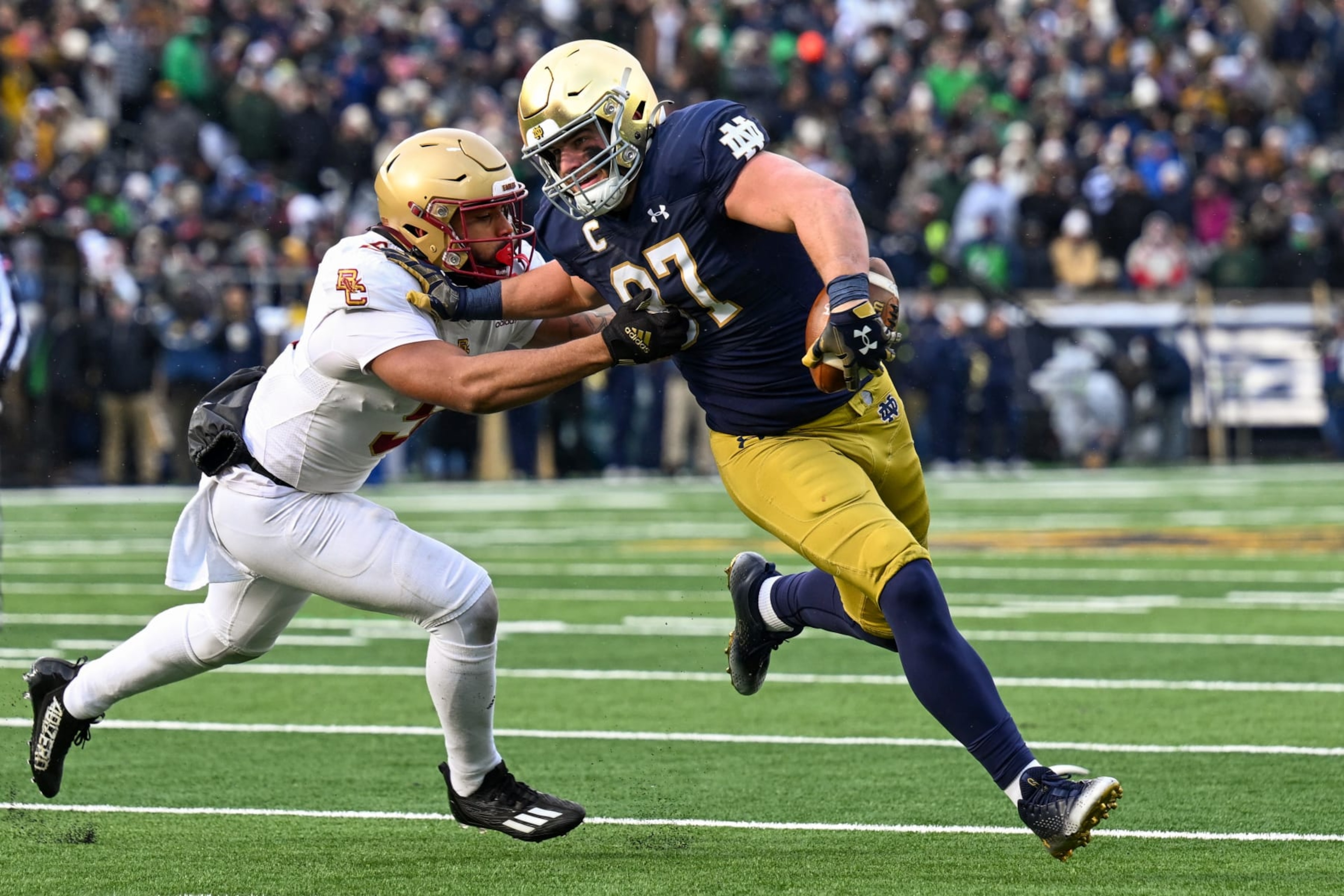 SOUTH BEND, INDIANA - NOVEMBER 19: Michael Mayer #87 of the Notre Dame Fighting Irish runs for a first down in the first half against Jaiden Woodbey #9 of the Boston College Eagles at Notre Dame Stadium on November 19, 2022 in South Bend, Indiana. (Photo by Quinn Harris/Getty Images)