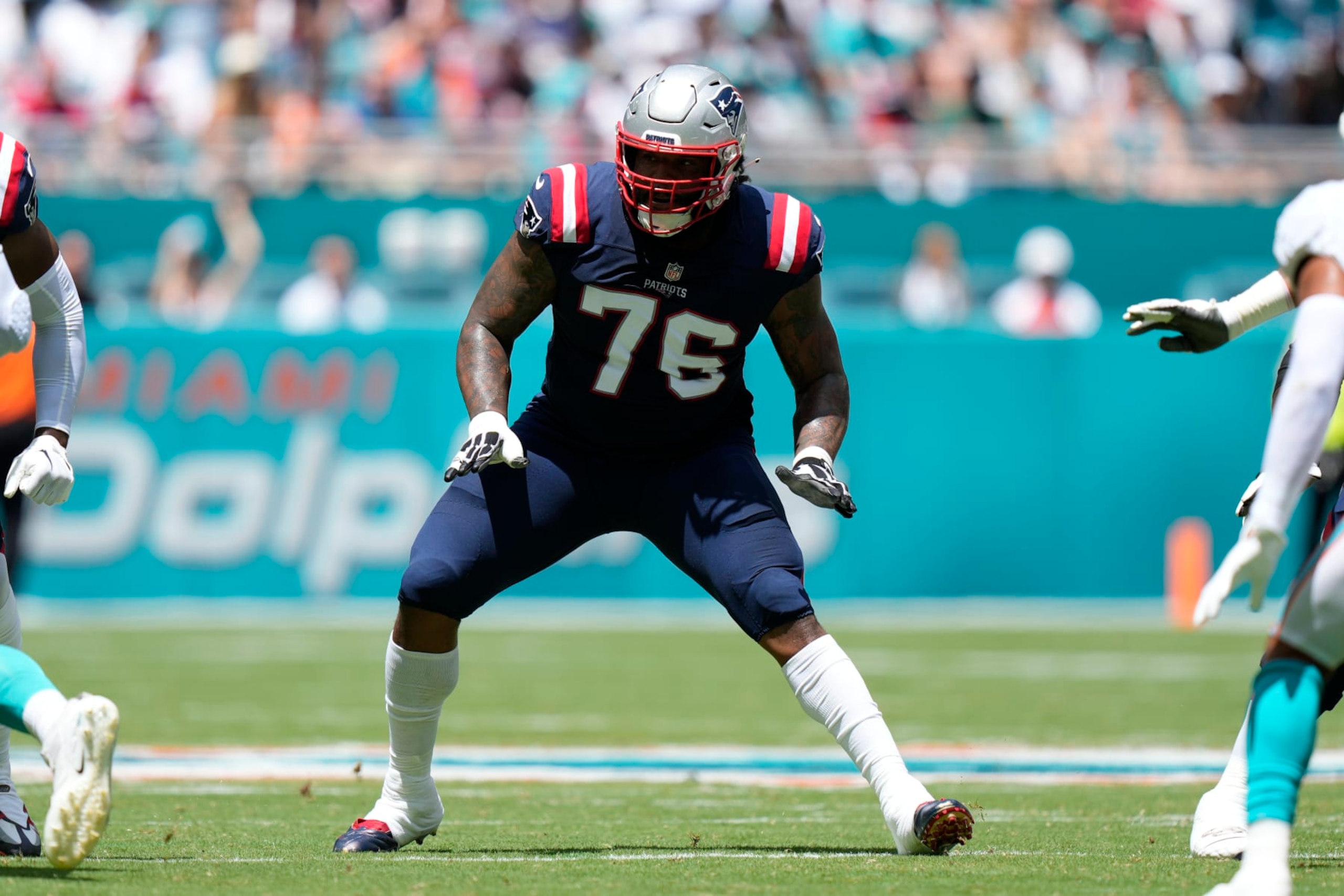 MIAMI GARDENS, FL - SEPTEMBER 11: New England Patriots offensive tackle Isaiah Wynn (76) blocks during the game between the New England Patriots and the Miami Dolphins, on Sunday, September 11, 2022 at Hard Rock Stadium in Miami Gardens, FL (Photo by Peter Joneleit/Icon Sportswire via Getty Images) MIAMI GARDENS, FL - SEPTEMBER 11: New England Patriots offensive tackle Isaiah Wynn (76) blocks during the game between the New England Patriots and the Miami Dolphins, on Sunday, September 11, 2022 at Hard Rock Stadium in Miami Gardens, FL (Photo by Peter Joneleit/Icon Sportswire via Getty Images)