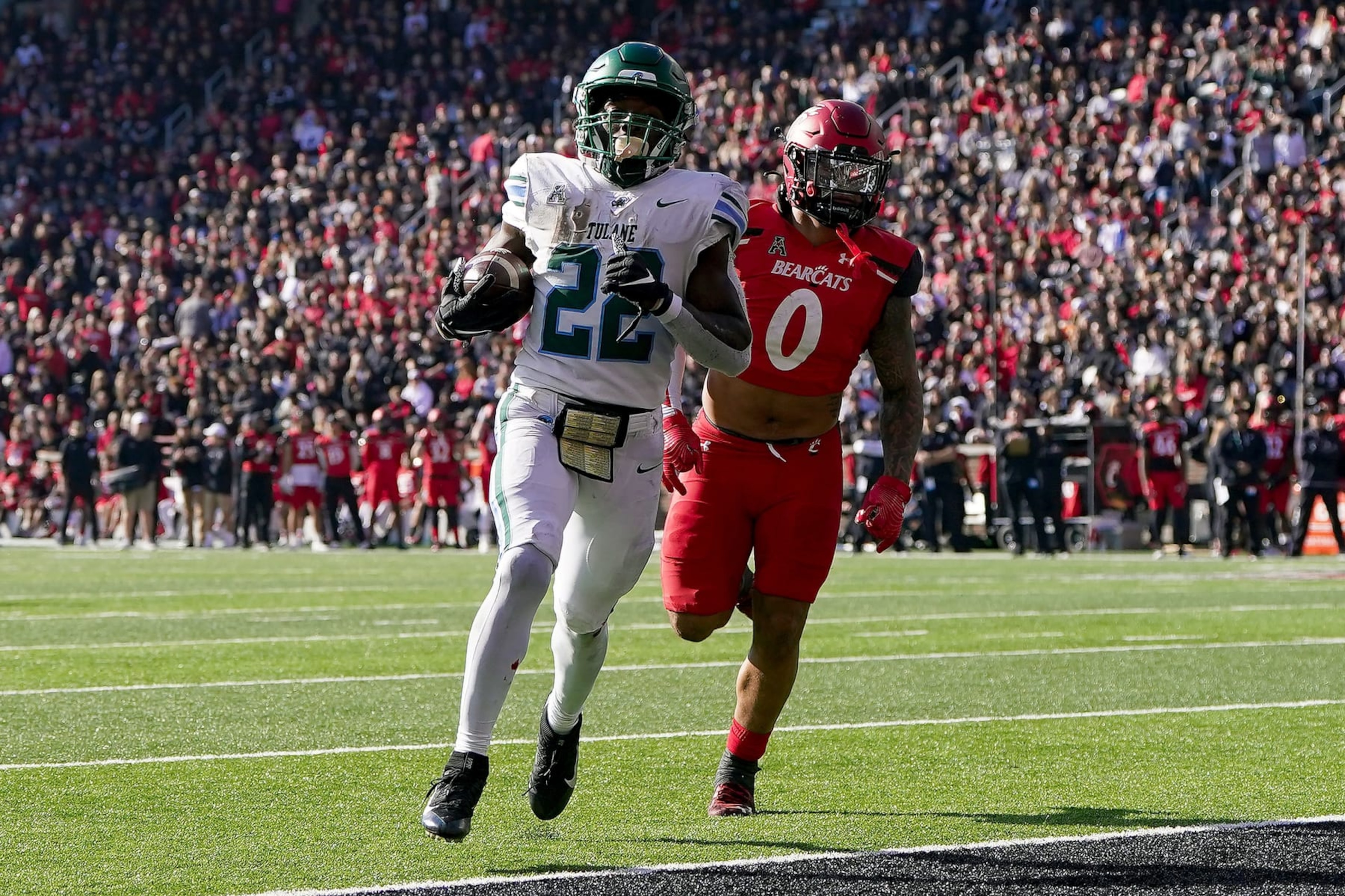 CINCINNATI, OHIO - NOVEMBER 25: Tyjae Spears #22 of the Tulane Green Wave scores a touchdown past Ivan Pace Jr. #0 of the Cincinnati Bearcats in the second quarter at Nippert Stadium on November 25, 2022 in Cincinnati, Ohio. (Photo by Dylan Buell/Getty Images) CINCINNATI, OHIO - NOVEMBER 25: Tyjae Spears #22 of the Tulane Green Wave scores a touchdown past Ivan Pace Jr. #0 of the Cincinnati Bearcats in the second quarter at Nippert Stadium on November 25, 2022 in Cincinnati, Ohio. (Photo by Dylan Buell/Getty Images)