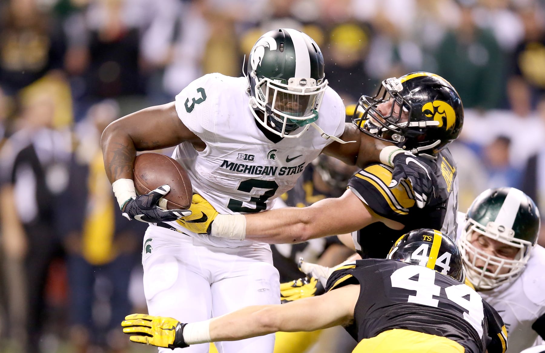 INDIANAPOLIS, IN - DECEMBER 05:  LJ Scott #3 of the Michigan State Spartans runs for the game winning touchdown against the Iowa Hawkeyes in the Big Ten Championship at Lucas Oil Stadium on December 5, 2015 in Indianapolis, Indiana.  (Photo by Andy Lyons/Getty Images)