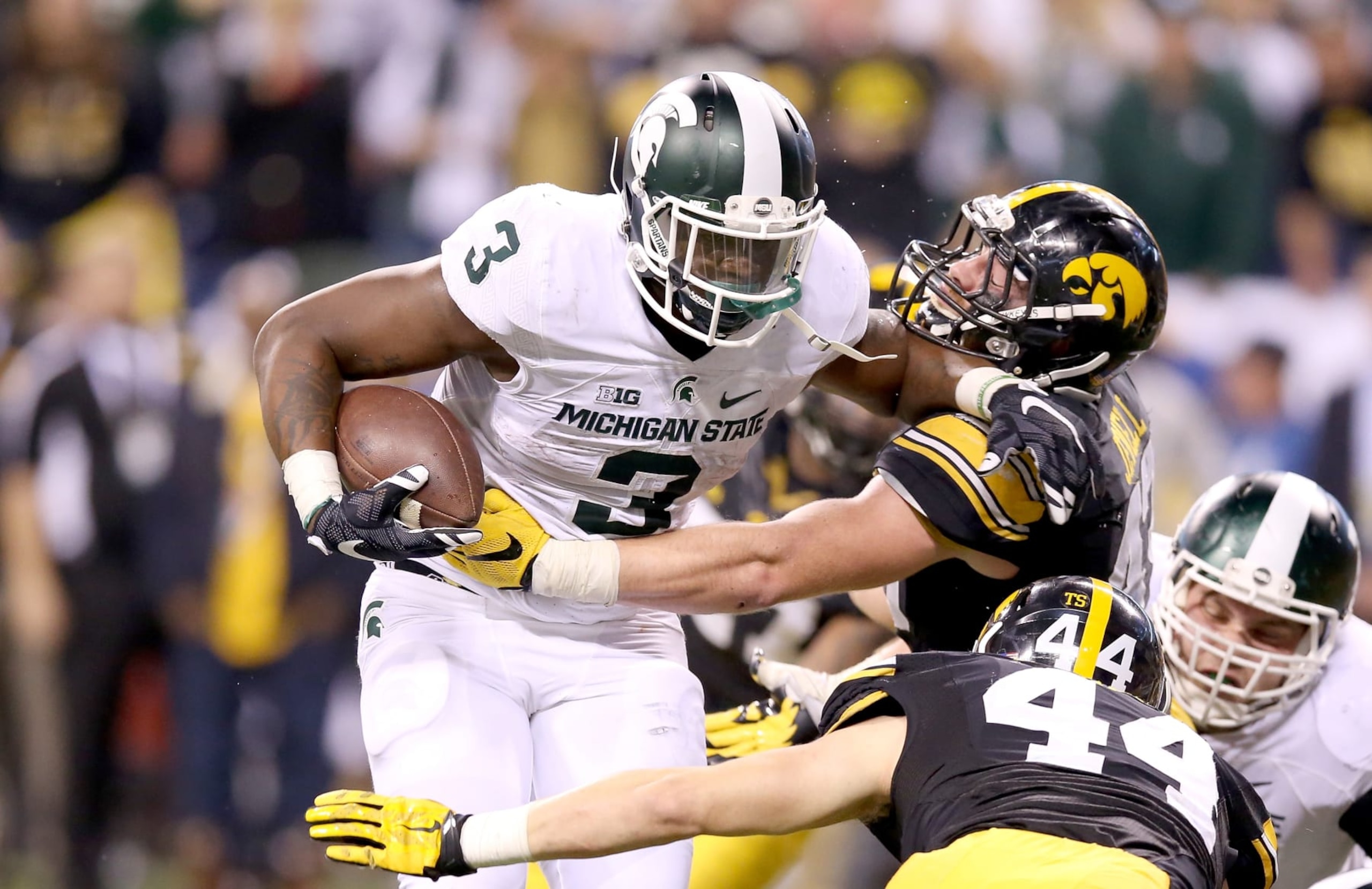 INDIANAPOLIS, IN - DECEMBER 05:  LJ Scott #3 of the Michigan State Spartans runs for the game winning touchdown against the Iowa Hawkeyes in the Big Ten Championship at Lucas Oil Stadium on December 5, 2015 in Indianapolis, Indiana.  (Photo by Andy Lyons/Getty Images)