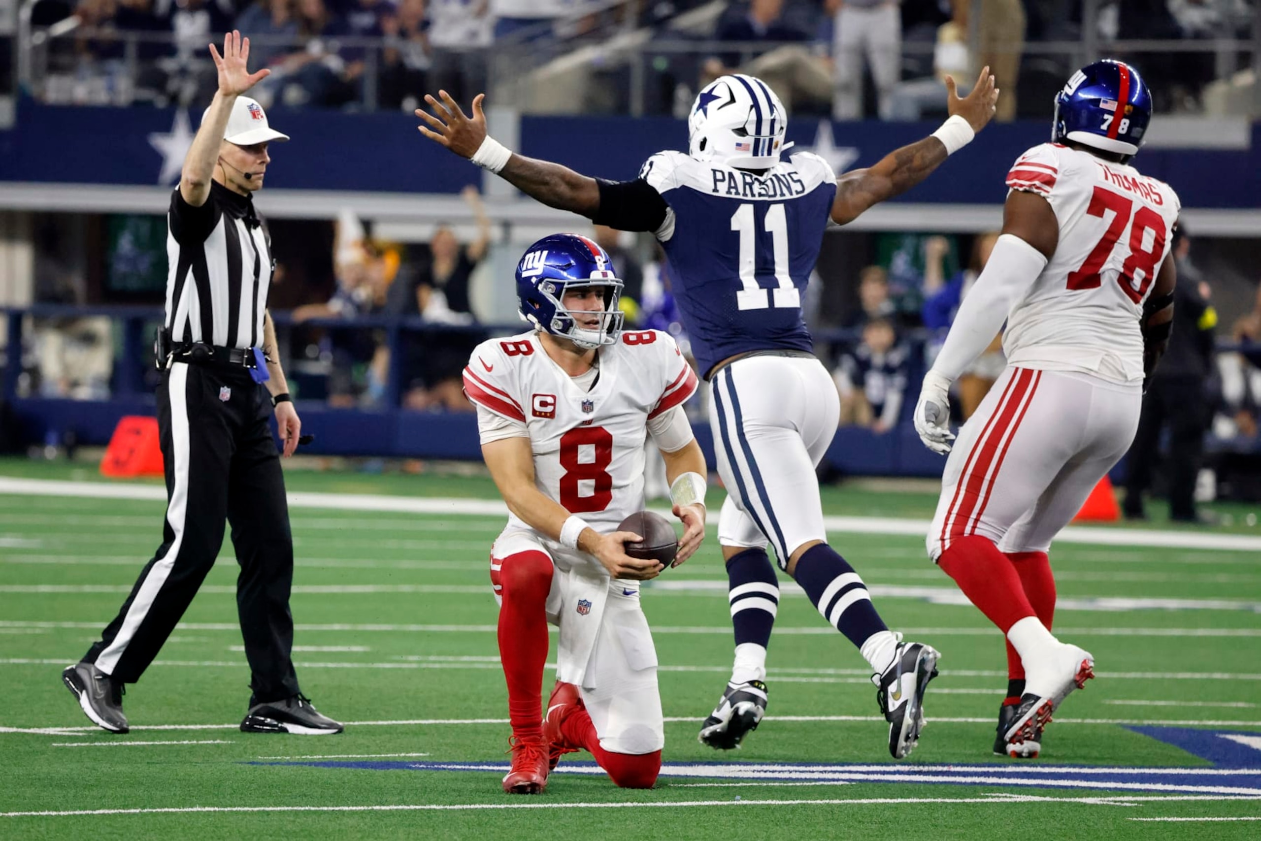 New York Giants quarterback Daniel Jones (8) is slow to get up after being sacked by Dallas Cowboys linebacker Micah Parsons (11) during the second half of an NFL football game Thursday, Nov. 24, 2022, in Arlington, Texas. (AP Photo/Michael Ainsworth) New York Giants quarterback Daniel Jones (8) is slow to get up after being sacked by Dallas Cowboys linebacker Micah Parsons (11) during the second half of an NFL football game Thursday, Nov. 24, 2022, in Arlington, Texas. (AP Photo/Michael Ainsworth)
