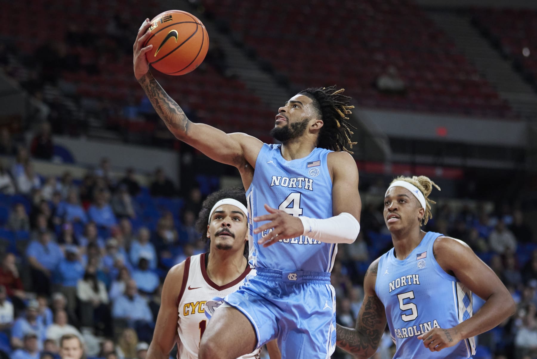 North Carolina guard R.J. Davis (4) shoots over Iowa State guard Jaren Holmes, left, during the first half of an NCAA college basketball game in the Phil Knight Invitational tournament in Portland, Ore., Friday, Nov. 25, 2022. (AP Photo/Craig Mitchelldyer)