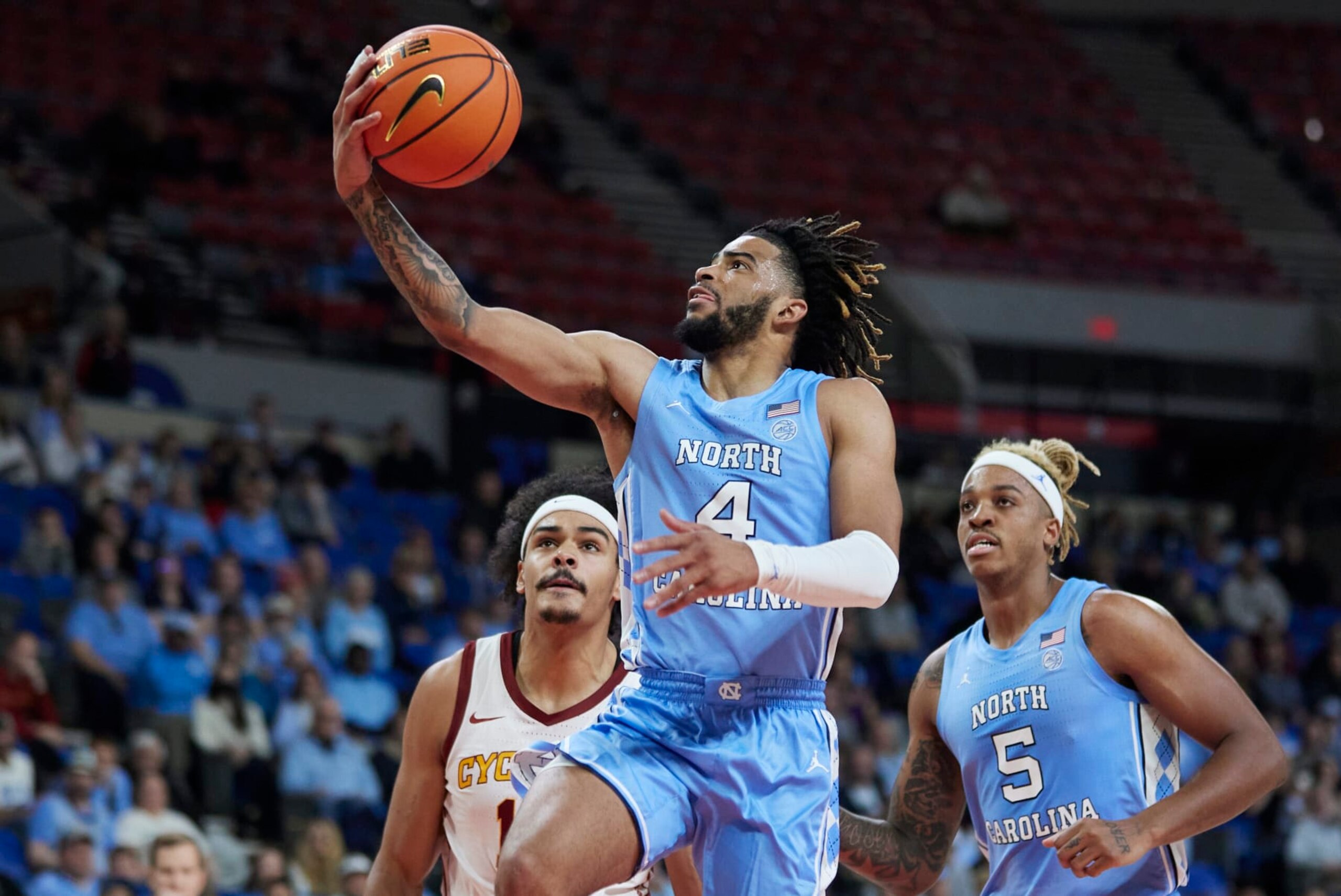 North Carolina guard R.J. Davis (4) shoots over Iowa State guard Jaren Holmes, left, during the first half of an NCAA college basketball game in the Phil Knight Invitational tournament in Portland, Ore., Friday, Nov. 25, 2022. (AP Photo/Craig Mitchelldyer) North Carolina guard R.J. Davis (4) shoots over Iowa State guard Jaren Holmes, left, during the first half of an NCAA college basketball game in the Phil Knight Invitational tournament in Portland, Ore., Friday, Nov. 25, 2022. (AP Photo/Craig Mitchelldyer)