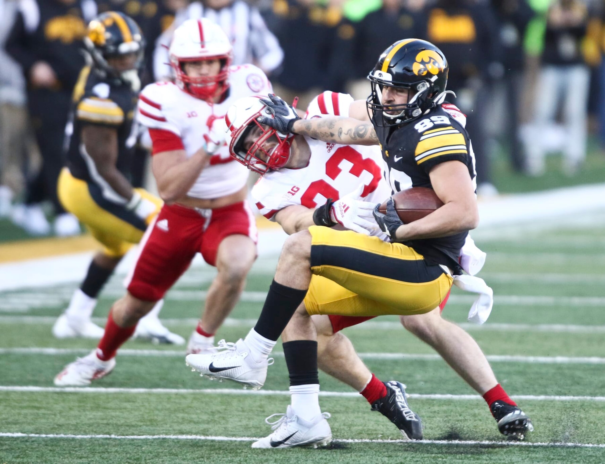 IOWA CITY, IOWA- NOVEMBER 25: Wide receiver Nico Ragaini #89 of the Iowa Hawkeyes breaks a tackle during the first half safety Isaac Gifford #23 of the Nebraska Cornhuskers at Kinnick Stadium, on November 25, 2022 in Iowa City, Iowa. (Photo by Matthew Holst/Getty Images) IOWA CITY, IOWA- NOVEMBER 25: Wide receiver Nico Ragaini #89 of the Iowa Hawkeyes breaks a tackle during the first half safety Isaac Gifford #23 of the Nebraska Cornhuskers at Kinnick Stadium, on November 25, 2022 in Iowa City, Iowa. (Photo by Matthew Holst/Getty Images)