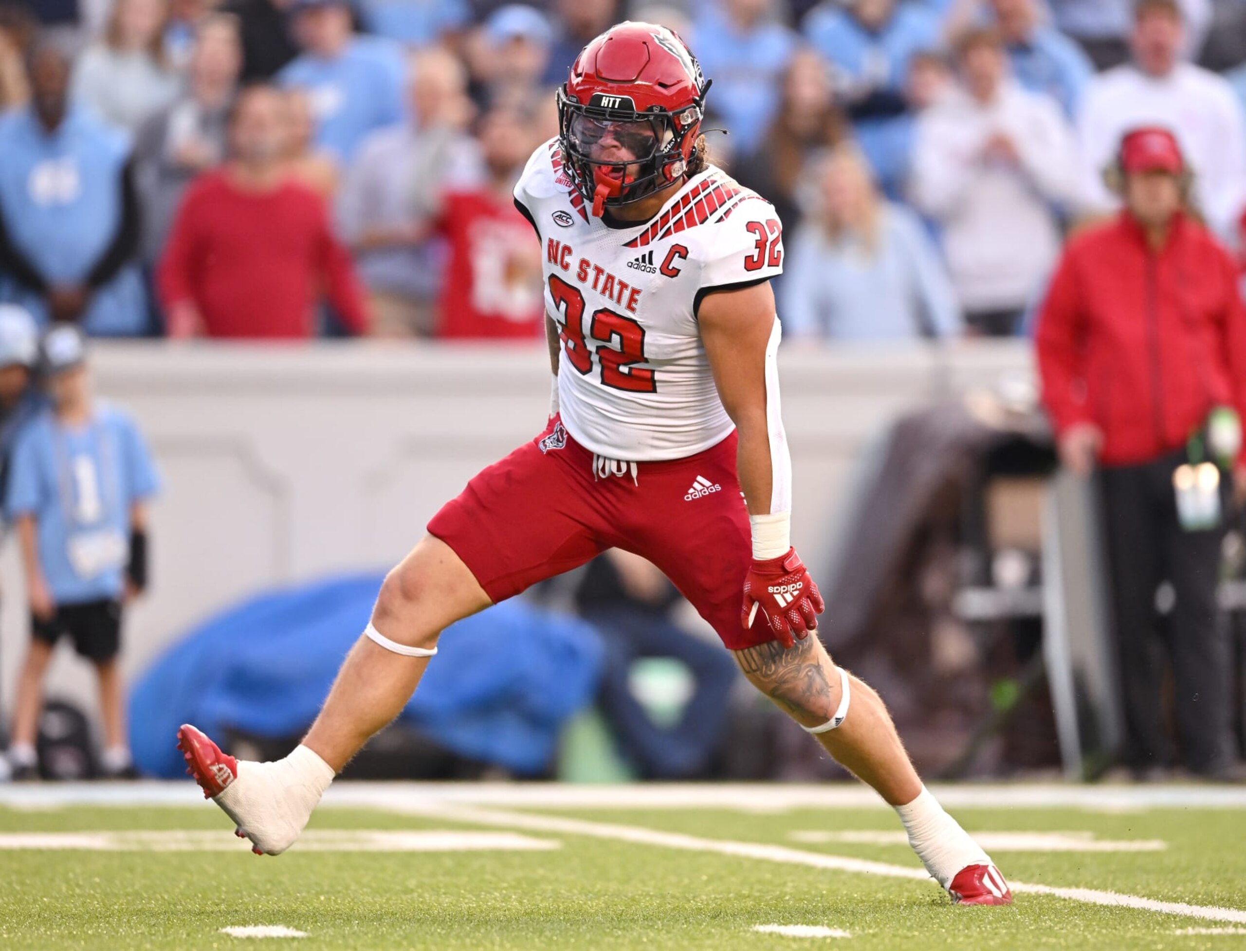 CHAPEL HILL, NORTH CAROLINA - NOVEMBER 25: Drake Thomas #32 of the North Carolina State Wolfpack reacts afrer a ssack of Drake Maye #10 of the North Carolina Tar Heels during the first half of their game at Kenan Memorial Stadium on November 25, 2022 in Chapel Hill, North Carolina. (Photo by Grant Halverson/Getty Images) CHAPEL HILL, NORTH CAROLINA - NOVEMBER 25: Drake Thomas #32 of the North Carolina State Wolfpack reacts afrer a ssack of Drake Maye #10 of the North Carolina Tar Heels during the first half of their game at Kenan Memorial Stadium on November 25, 2022 in Chapel Hill, North Carolina. (Photo by Grant Halverson/Getty Images)