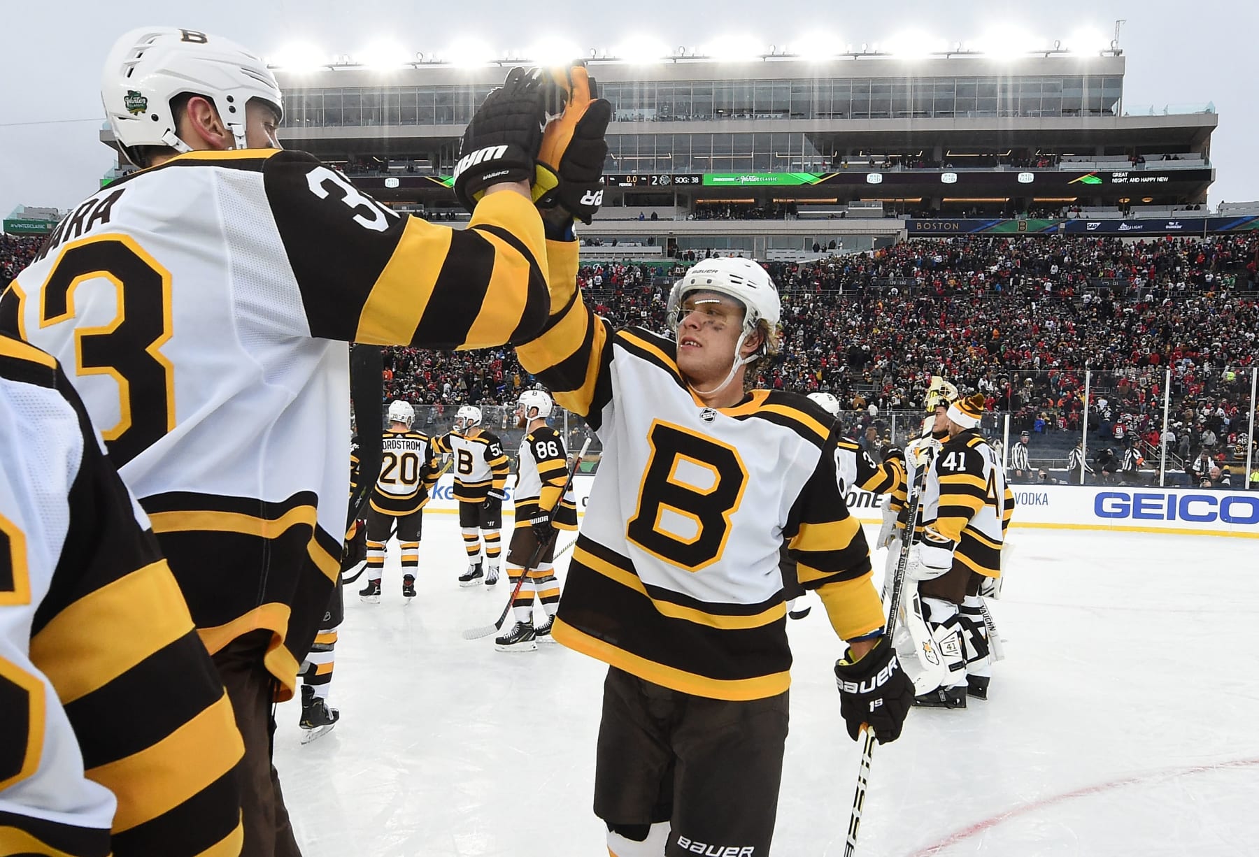 SOUTH BEND, IN - JANUARY 01: Zdeno Chara #33 and David Pastrnak #88 of the Boston Bruins celebrate after the 2019 Bridgestone NHL Winter Classic against the Chicago Blackhawks at Notre Dame Stadium on January 1, 2019 in South Bend, Indiana. The Bruins defeated the Blackhawks 4-2.  (Photo by Brian Babineau/NHLI via Getty Images)