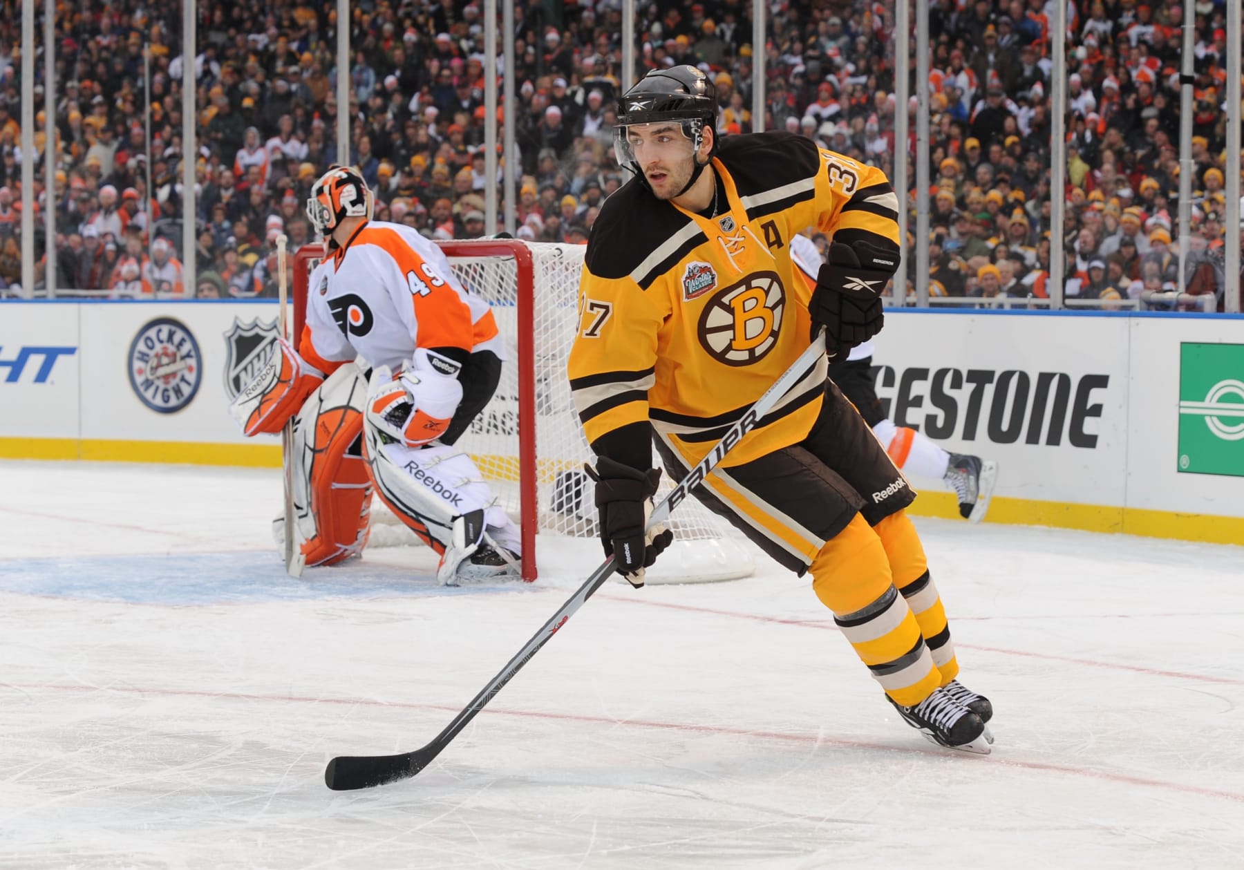 BOSTON - JANUARY 1: Patrice Bergeron #37 of the Boston Bruins skates up the ice against the Philadelphia Flyers in the 2010 Bridgestone Winter Classic at Fenway Park on January 1, 2010 in Boston, Massachusetts. (Photo by Brian Babineau/NHLI via Getty Images)