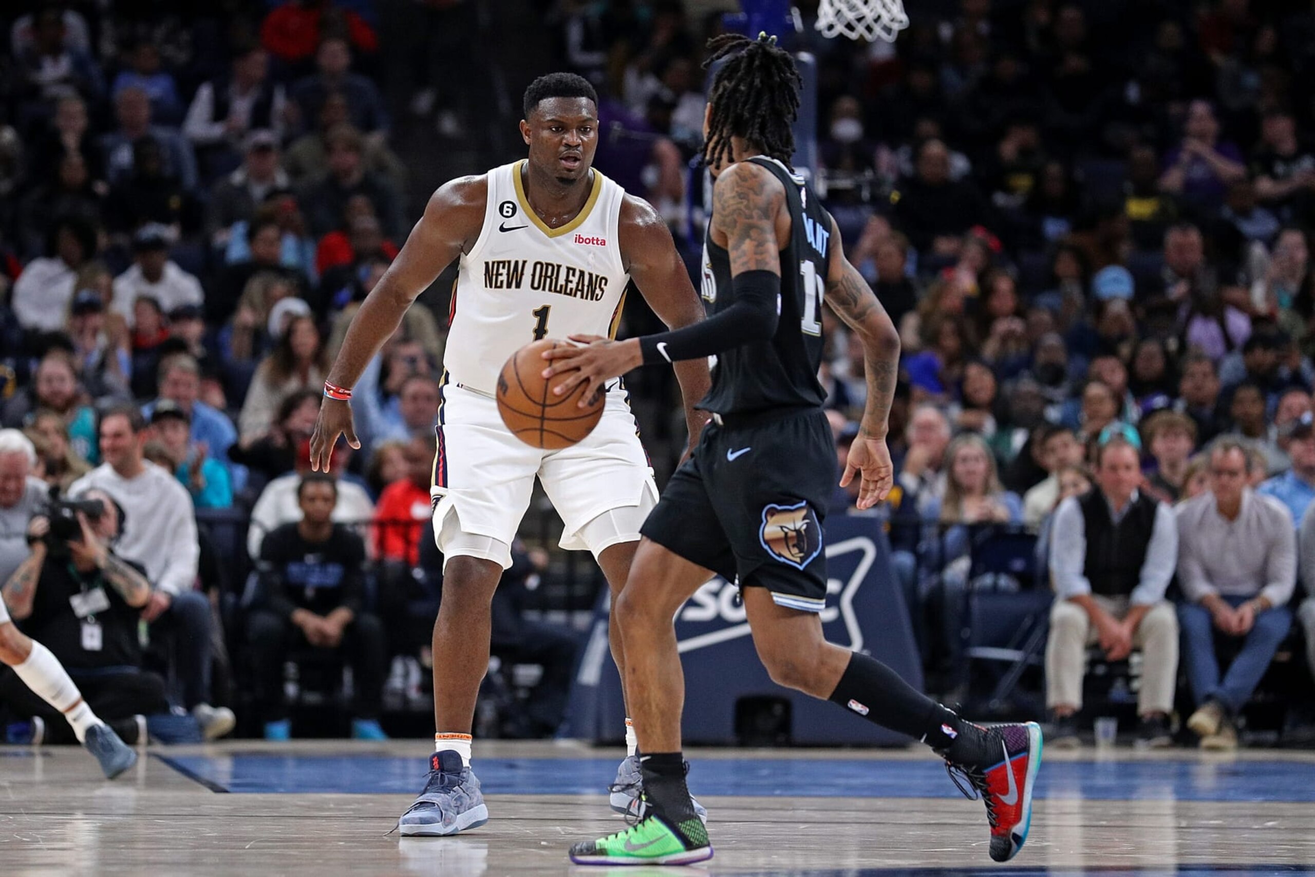 MEMPHIS, TENNESSEE - NOVEMBER 25: Ja Morant #12 of the Memphis Grizzlies handles the ball against Zion Williamson #1 of the New Orleans Pelicans during the first half at FedExForum on November 25, 2022 in Memphis, Tennessee. NOTE TO USER: User expressly acknowledges and agrees that, by downloading and or using this photograph, User is consenting to the terms and conditions of the Getty Images License Agreement. (Photo by Justin Ford/Getty Images) MEMPHIS, TENNESSEE - NOVEMBER 25: Ja Morant #12 of the Memphis Grizzlies handles the ball against Zion Williamson #1 of the New Orleans Pelicans during the first half at FedExForum on November 25, 2022 in Memphis, Tennessee. NOTE TO USER: User expressly acknowledges and agrees that, by downloading and or using this photograph, User is consenting to the terms and conditions of the Getty Images License Agreement. (Photo by Justin Ford/Getty Images)