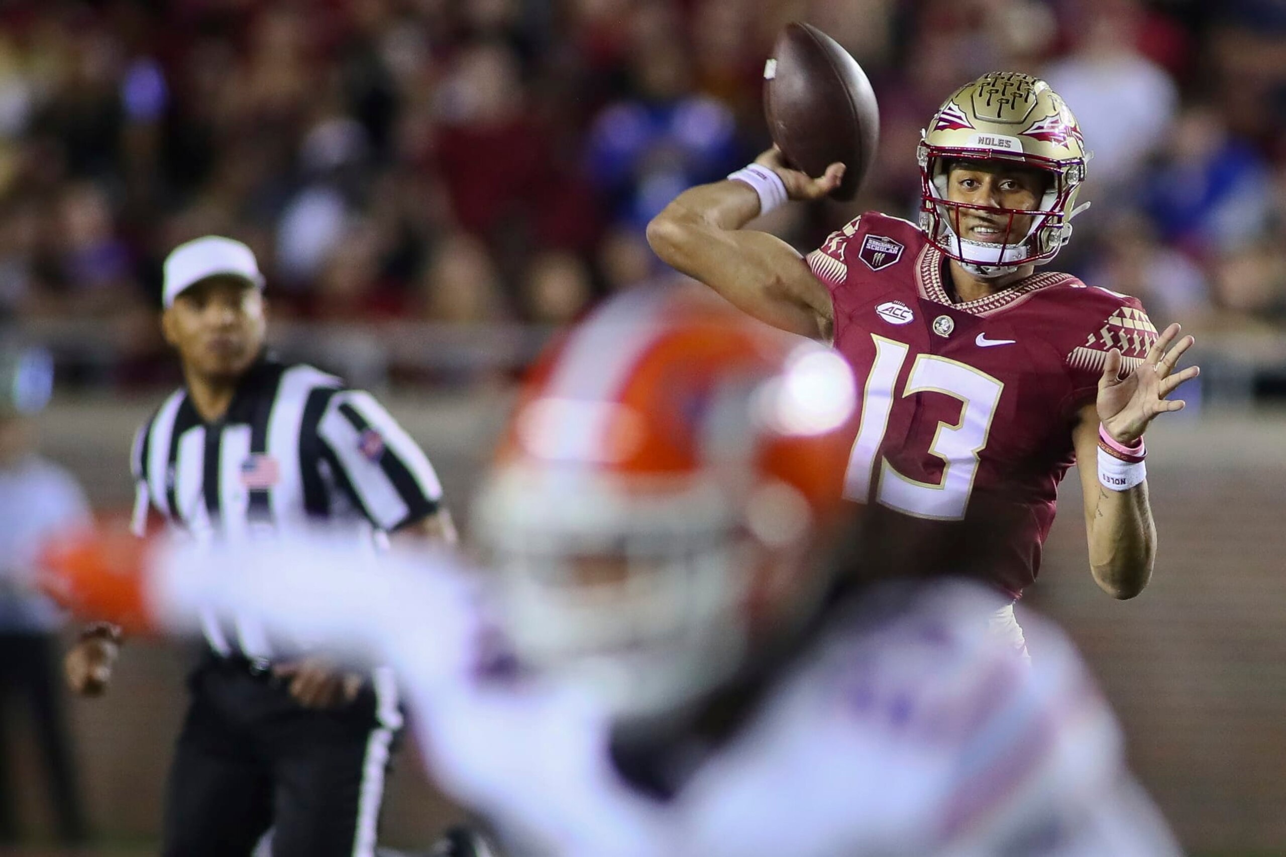 Florida State quarterback Jordan Travis (13) throws in the first quarter of an NCAA college football game against Florida, Friday, Nov. 25, 2022, in Tallahassee, Fla. (AP Photo/Phil Sears) Florida State quarterback Jordan Travis (13) throws in the first quarter of an NCAA college football game against Florida, Friday, Nov. 25, 2022, in Tallahassee, Fla. (AP Photo/Phil Sears)