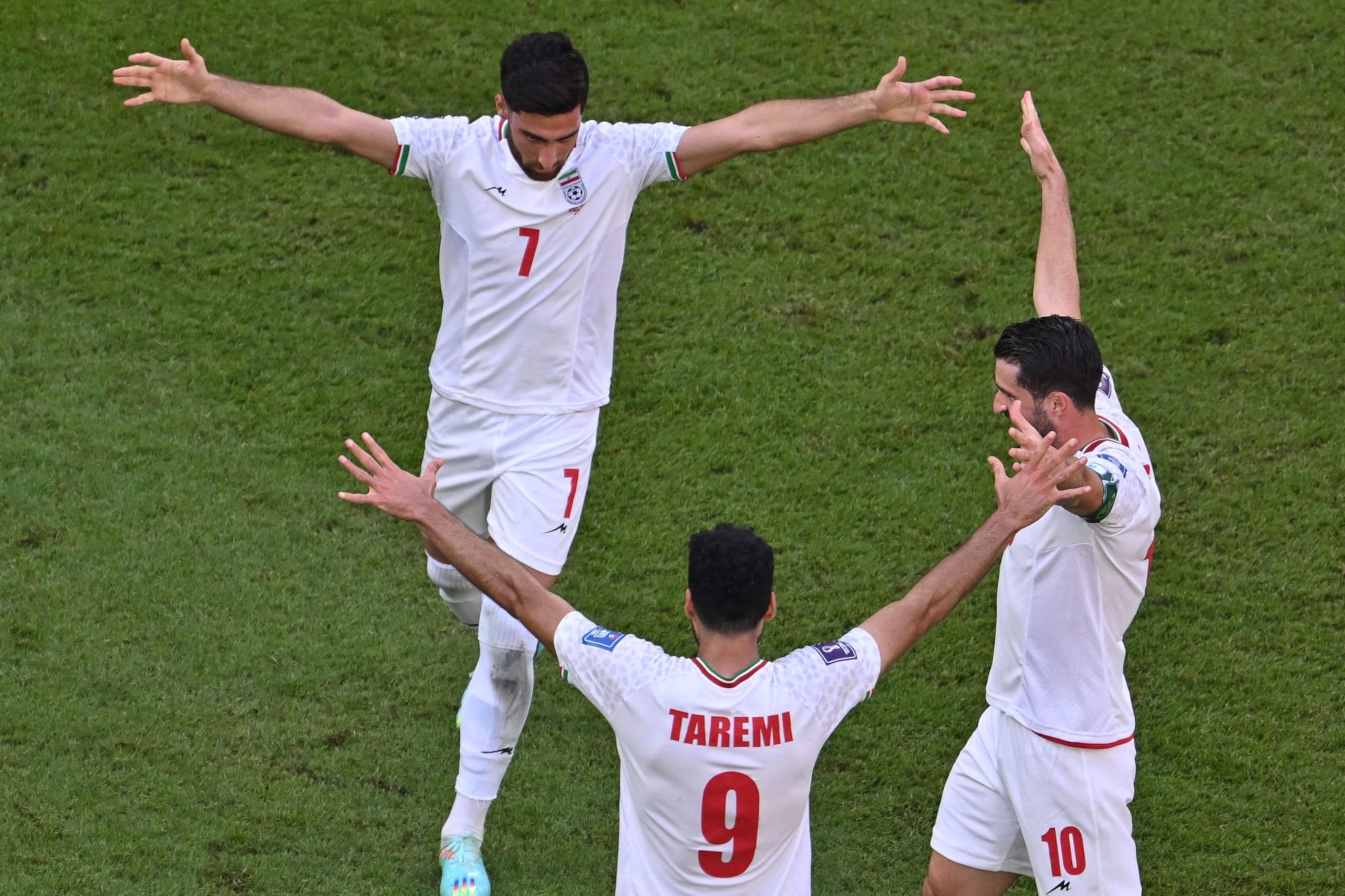 Iran's midfielder #07 Alireza Jahanbakhsh, Iran's forward #09 Mehdi Taremi, and Iran's forward #10 Karim Ansarifard celebrate the team's victory during the Qatar 2022 World Cup Group B football match between Wales and Iran at the Ahmad Bin Ali Stadium in Al-Rayyan, west of Doha on November 25, 2022. (Photo by Antonin THUILLIER / AFP) (Photo by ANTONIN THUILLIER/AFP via Getty Images) Iran's midfielder #07 Alireza Jahanbakhsh, Iran's forward #09 Mehdi Taremi, and Iran's forward #10 Karim Ansarifard celebrate the team's victory during the Qatar 2022 World Cup Group B football match between Wales and Iran at the Ahmad Bin Ali Stadium in Al-Rayyan, west of Doha on November 25, 2022. (Photo by Antonin THUILLIER / AFP) (Photo by ANTONIN THUILLIER/AFP via Getty Images)