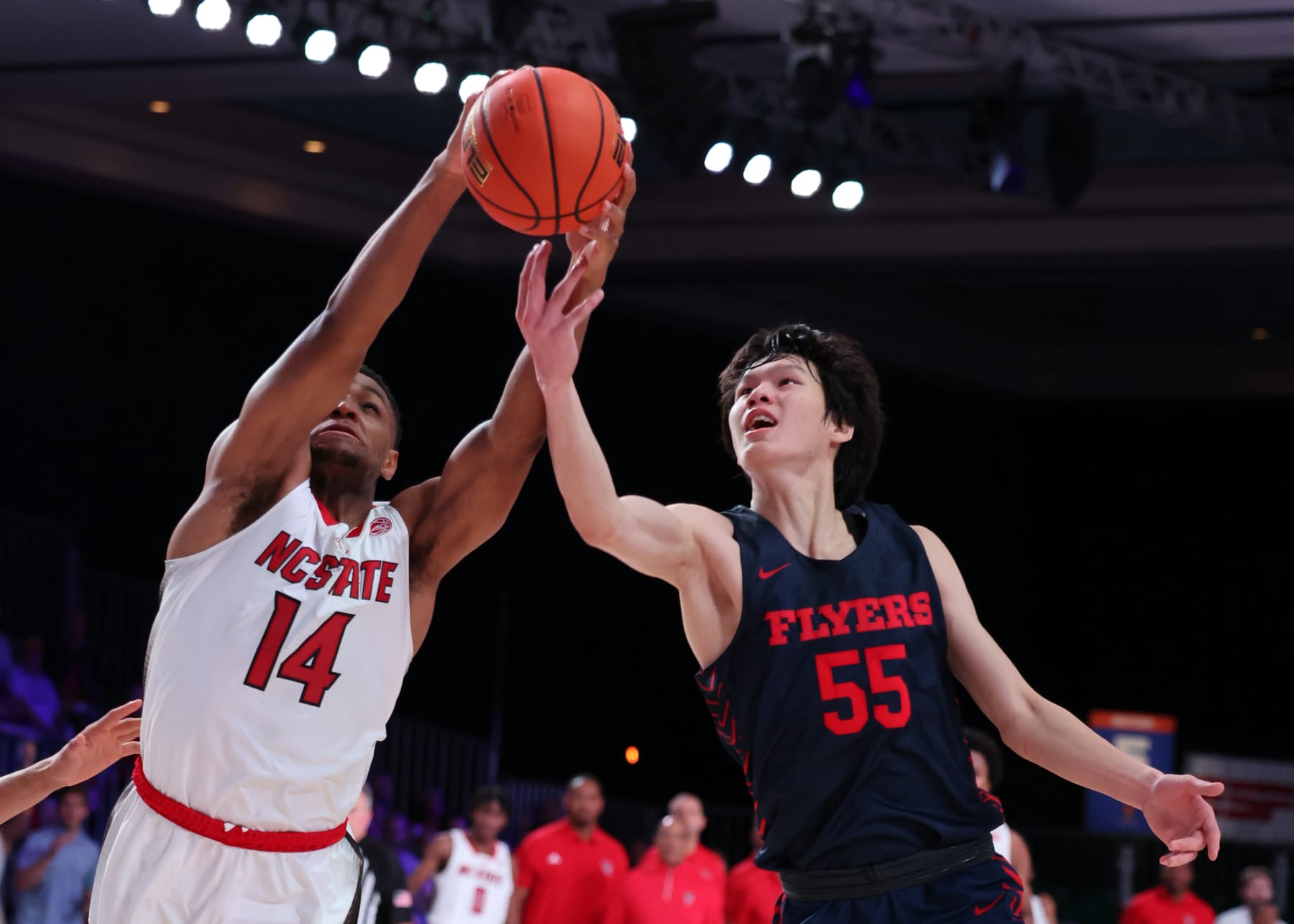Dayton's Mike Sharavjamts and NC State's Casey Morsell