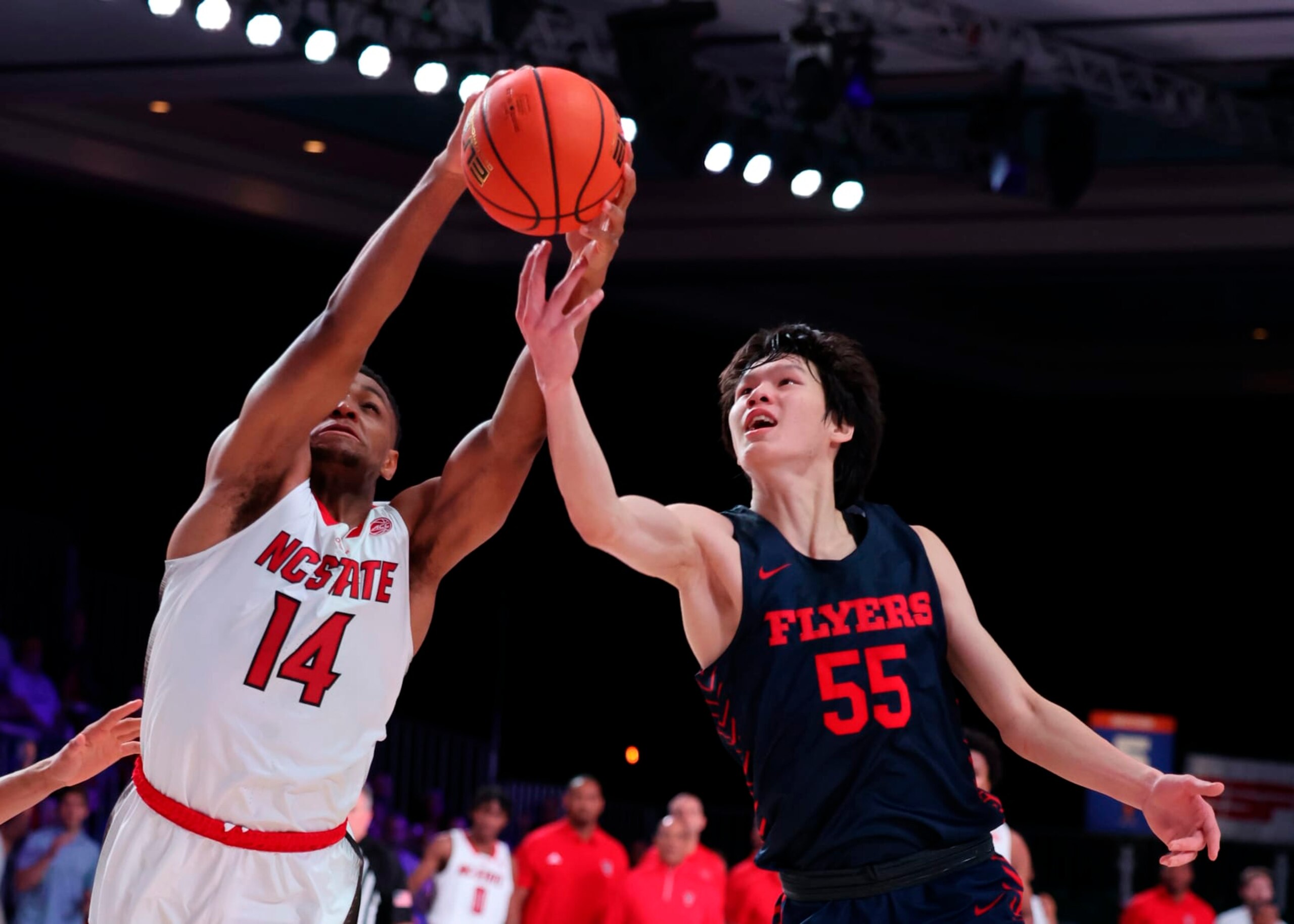 Dayton's Mike Sharavjamts and NC State's Casey Morsell