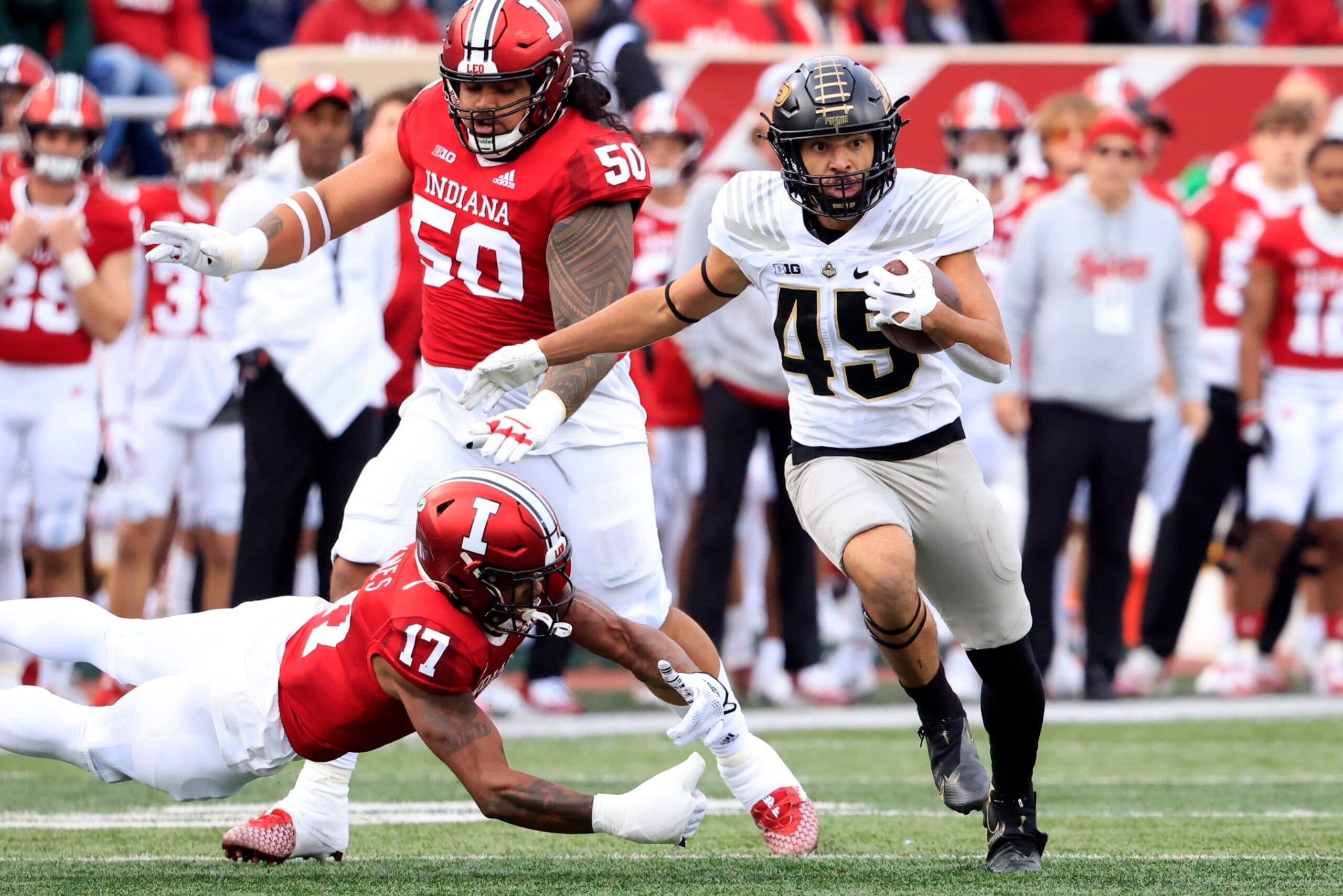 BLOOMINGTON, INDIANA - NOVEMBER 26: Devin Mockobee #45 of the Purdue Boilermakers avoids a tackle from Jonathan Haynes #17 of the Indiana Hoosiers during the first half at Memorial Stadium on November 26, 2022 in Bloomington, Indiana. (Photo by Justin Casterline/Getty Images) BLOOMINGTON, INDIANA - NOVEMBER 26: Devin Mockobee #45 of the Purdue Boilermakers avoids a tackle from Jonathan Haynes #17 of the Indiana Hoosiers during the first half at Memorial Stadium on November 26, 2022 in Bloomington, Indiana. (Photo by Justin Casterline/Getty Images)