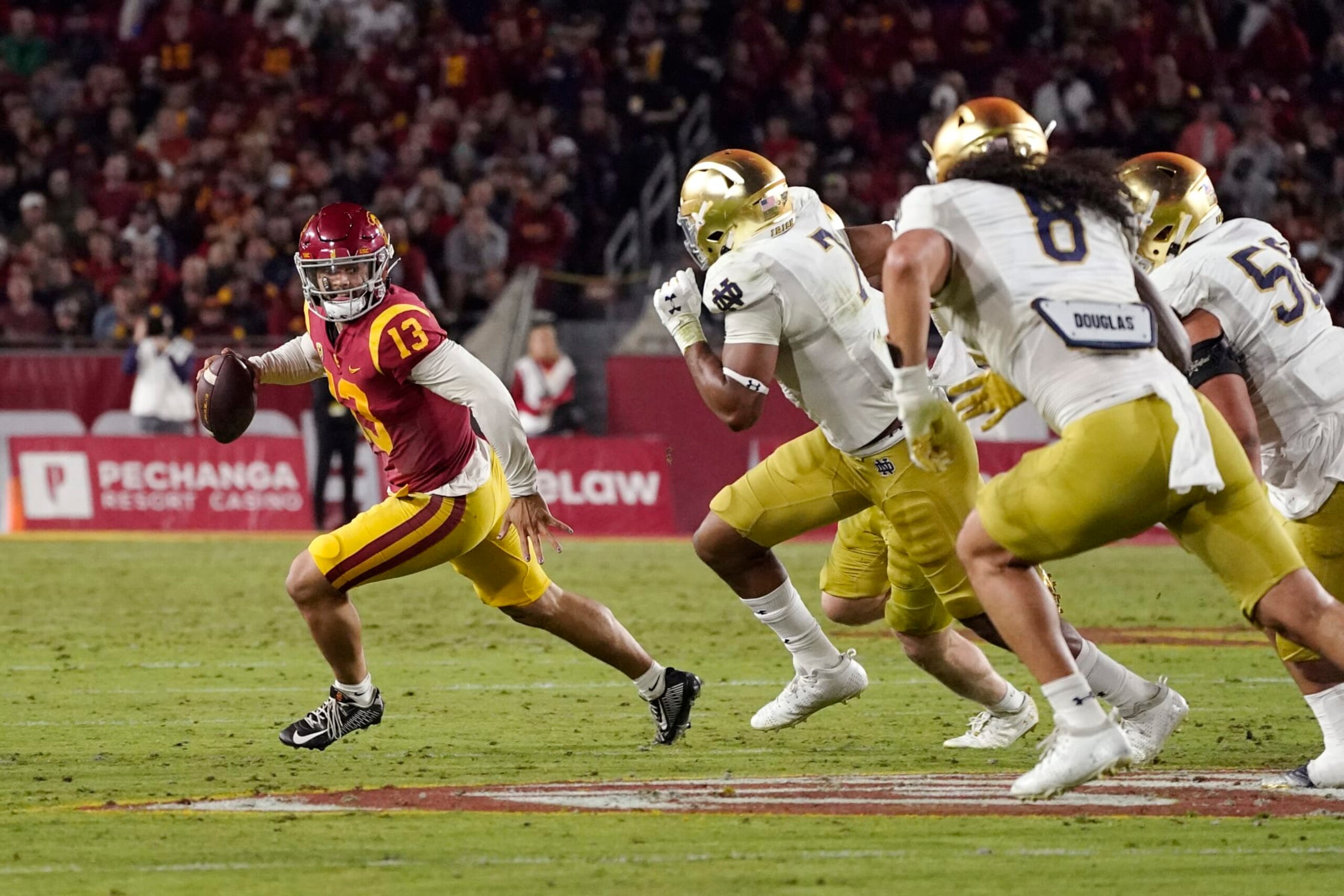 Southern California quarterback Caleb Williams, left, is chase by members of Notre Dame during the first half of an NCAA college football game Saturday, Nov. 26, 2022, in Los Angeles. (AP Photo/Mark J. Terrill) Southern California quarterback Caleb Williams, left, is chase by members of Notre Dame during the first half of an NCAA college football game Saturday, Nov. 26, 2022, in Los Angeles. (AP Photo/Mark J. Terrill)