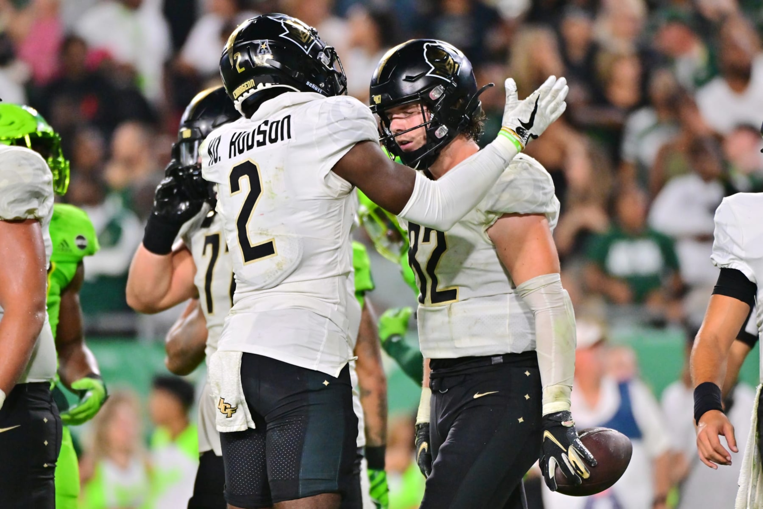 TAMPA, FLORIDA - NOVEMBER 26: Kobe Hudson #2 of the UCF Knights reacts qwith Alec Holler #82 of the UCF Knights after a go-ahead touchdown in the fourth quarter against the South Florida Bulls at Raymond James Stadium on November 26, 2022 in Tampa, Florida. (Photo by Julio Aguilar/Getty Images) TAMPA, FLORIDA - NOVEMBER 26: Kobe Hudson #2 of the UCF Knights reacts qwith Alec Holler #82 of the UCF Knights after a go-ahead touchdown in the fourth quarter against the South Florida Bulls at Raymond James Stadium on November 26, 2022 in Tampa, Florida. (Photo by Julio Aguilar/Getty Images)