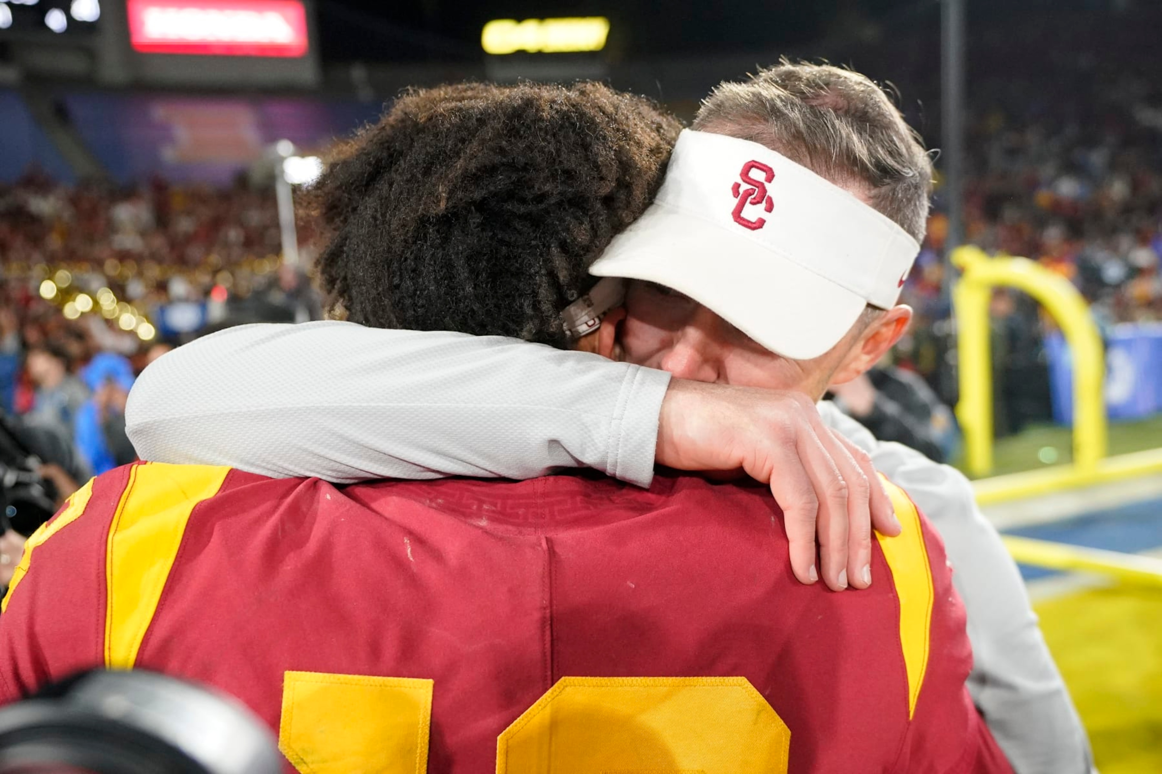 Southern California quarterback Caleb Williams, left, gets a hug from head coach Lincoln Riley after USC defeated UCLA 48-45 in an NCAA college football game Saturday, Nov. 19, 2022, in Pasadena, Calif. (AP Photo/Mark J. Terrill) Southern California quarterback Caleb Williams, left, gets a hug from head coach Lincoln Riley after USC defeated UCLA 48-45 in an NCAA college football game Saturday, Nov. 19, 2022, in Pasadena, Calif. (AP Photo/Mark J. Terrill)