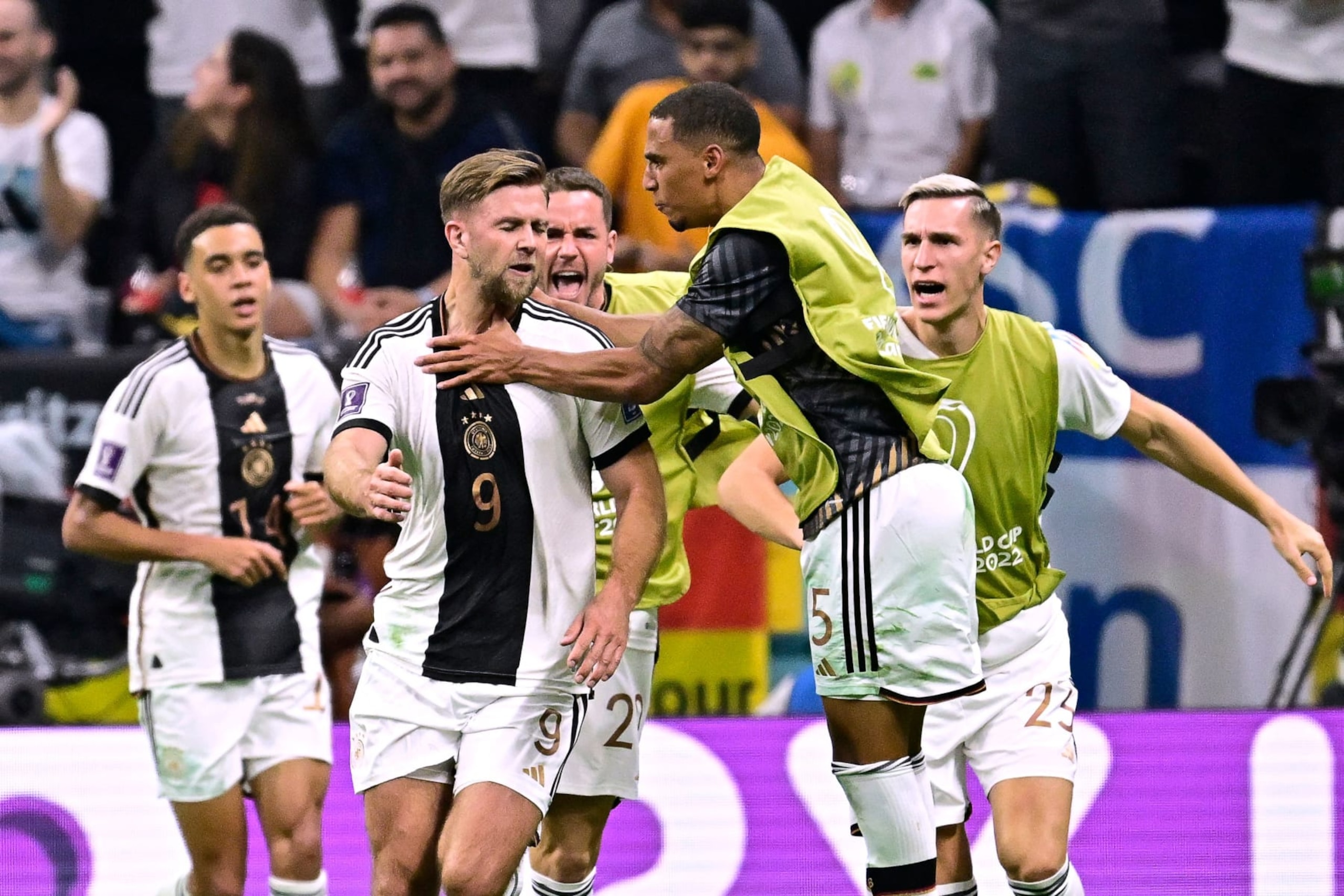 Germany's forward #09 Niclas Fullkrug (2nd L) celebrates with teammantes after scoring his team's first goal during the Qatar 2022 World Cup Group E football match between Spain and Germany at the Al-Bayt Stadium in Al Khor, north of Doha on November 27, 2022. (Photo by JAVIER SORIANO / AFP) (Photo by JAVIER SORIANO/AFP via Getty Images)