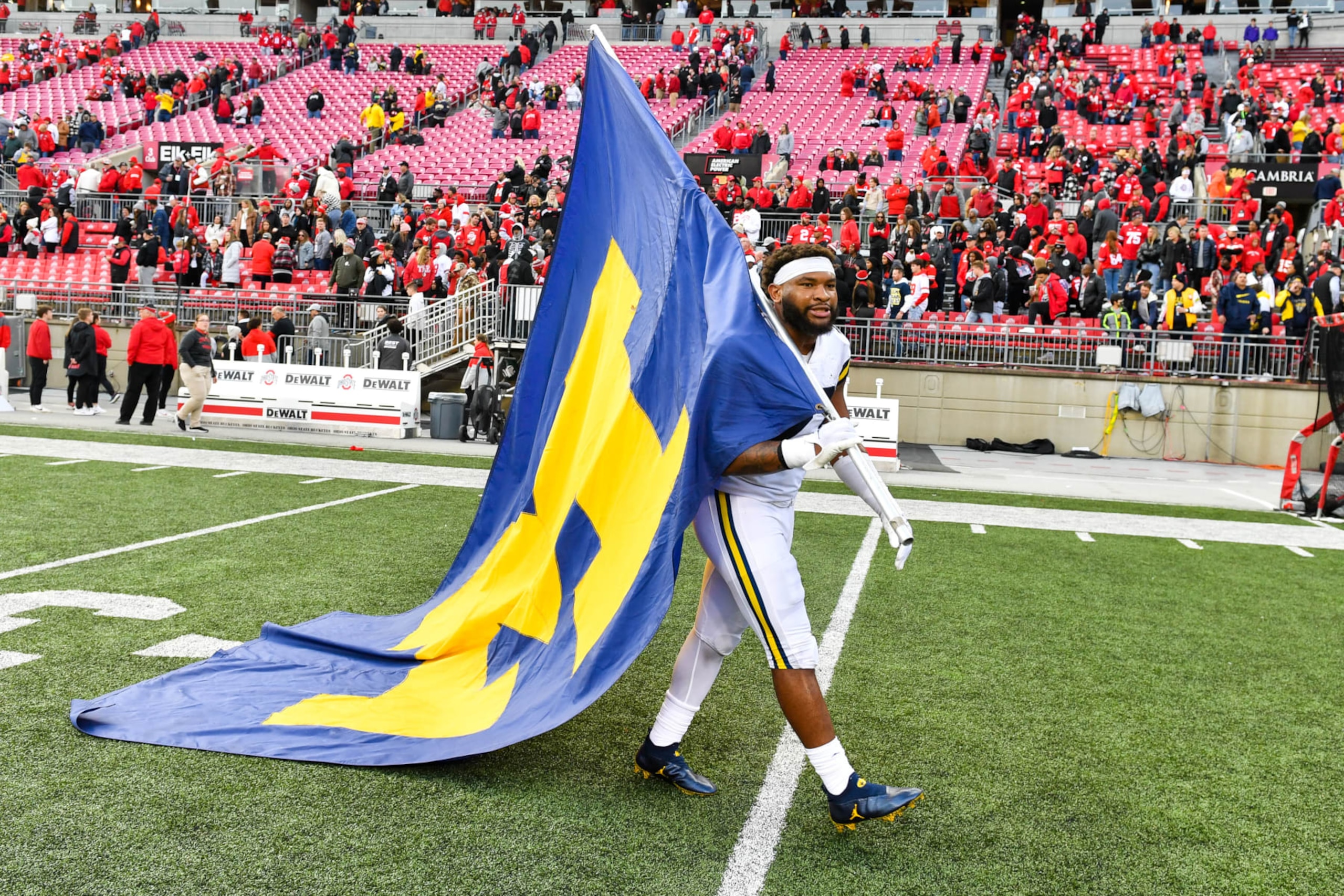 COLUMBUS, OHIO - NOVEMBER 26: Michael Barrett #23 of the Michigan Wolverines celebrates with the University of Michigan Flag after a college football game against the Ohio State Buckeyes at Ohio Stadium on November 26, 2022 in Columbus, Ohio. The Michigan Wolverines won the game 45-23 over the Ohio State Buckeyes and clinched the Big Ten East. (Photo by Aaron J. Thornton/Getty Images) COLUMBUS, OHIO - NOVEMBER 26: Michael Barrett #23 of the Michigan Wolverines celebrates with the University of Michigan Flag after a college football game against the Ohio State Buckeyes at Ohio Stadium on November 26, 2022 in Columbus, Ohio. The Michigan Wolverines won the game 45-23 over the Ohio State Buckeyes and clinched the Big Ten East. (Photo by Aaron J. Thornton/Getty Images)