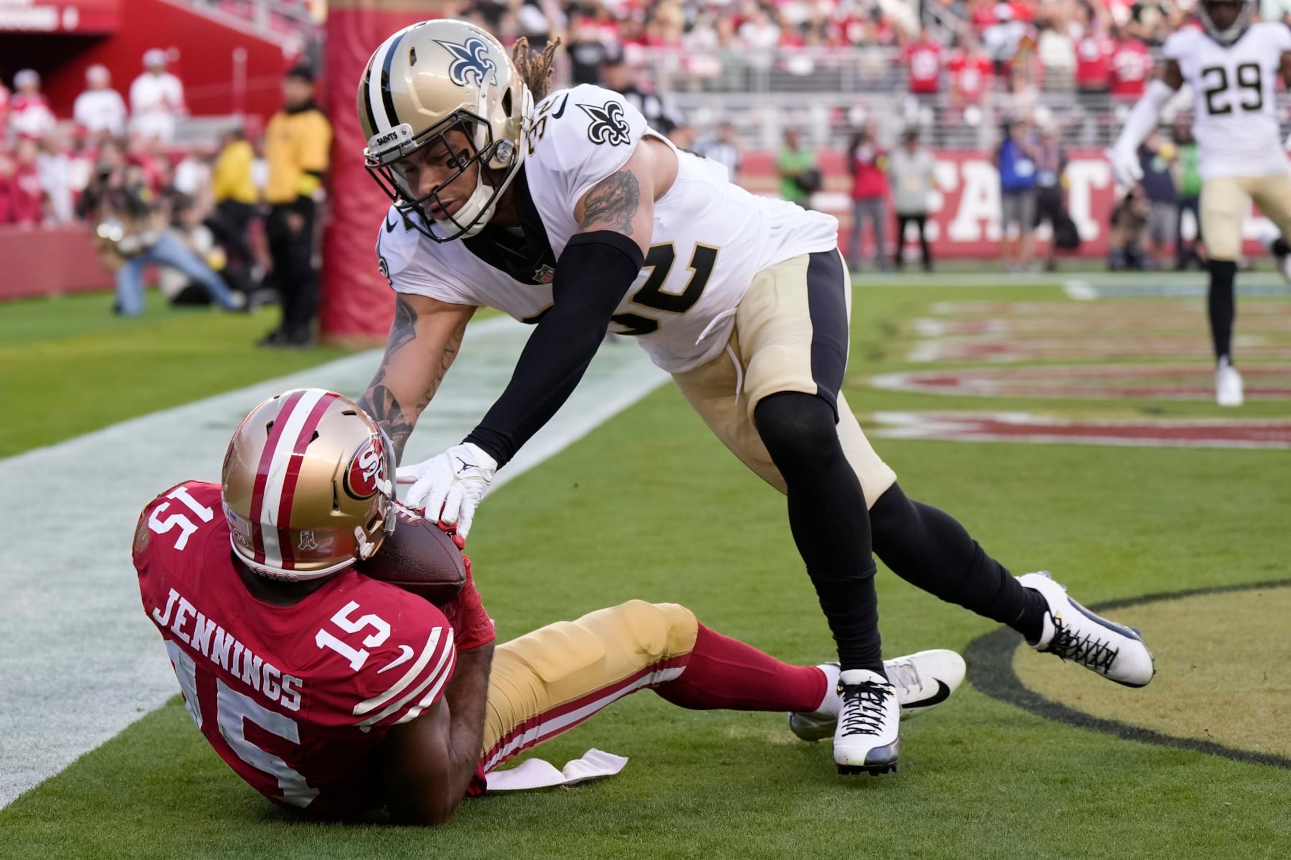 SANTA CLARA, CALIFORNIA - NOVEMBER 27: Jauan Jennings #15 of the San Francisco 49ers catches a touchdown pass while defended by Tyrann Mathieu #32 of the New Orleans Saints during the first half at Levi's Stadium on November 27, 2022 in Santa Clara, California. (Photo by Thearon W. Henderson/Getty Images)
