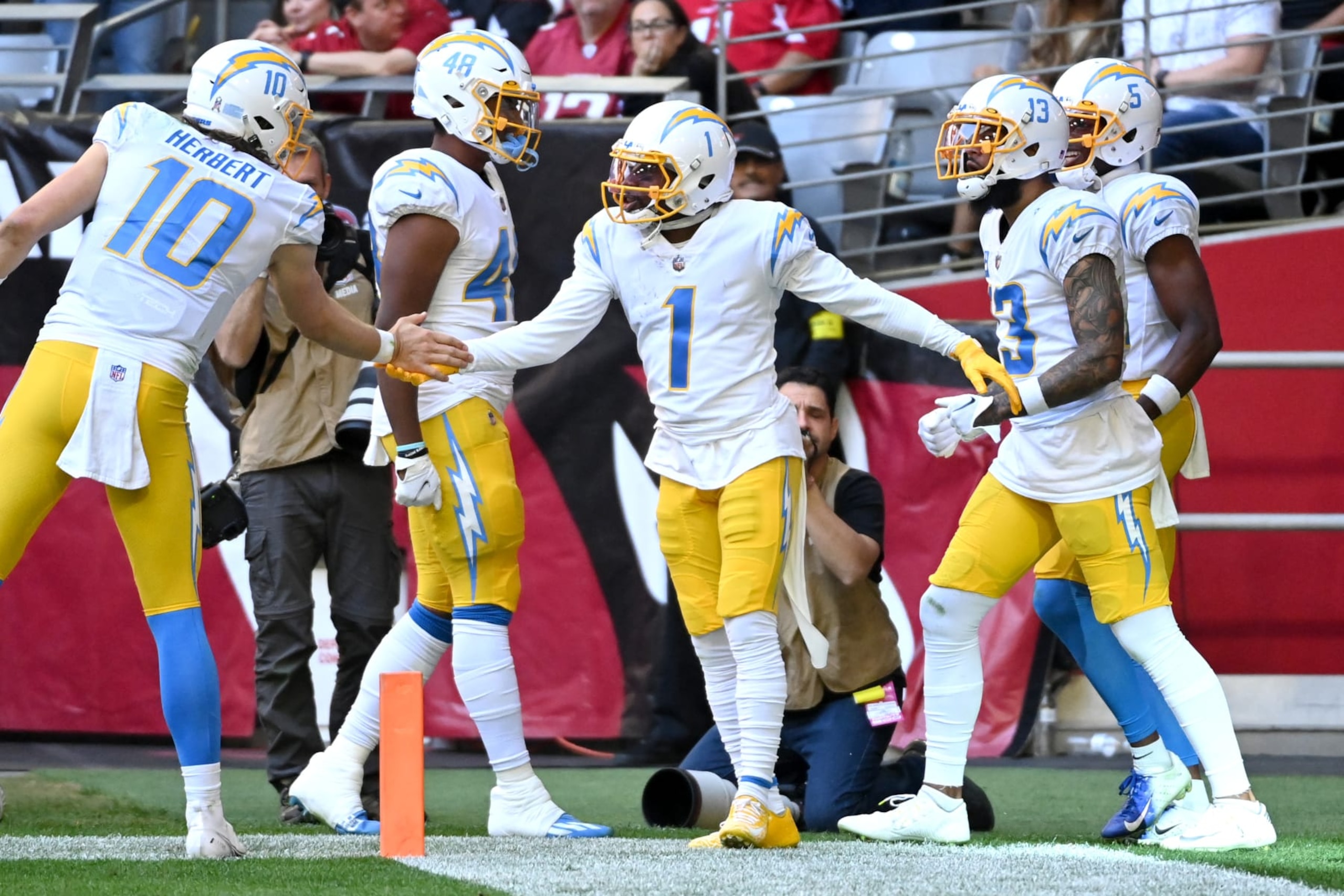 GLENDALE, ARIZONA - NOVEMBER 27: DeAndre Carter #1 of the Los Angeles Chargers celebrates with teammates after scoring a touchdown in the second quarter of a game against the Arizona Cardinals at State Farm Stadium on November 27, 2022 in Glendale, Arizona. (Photo by Norm Hall/Getty Images)