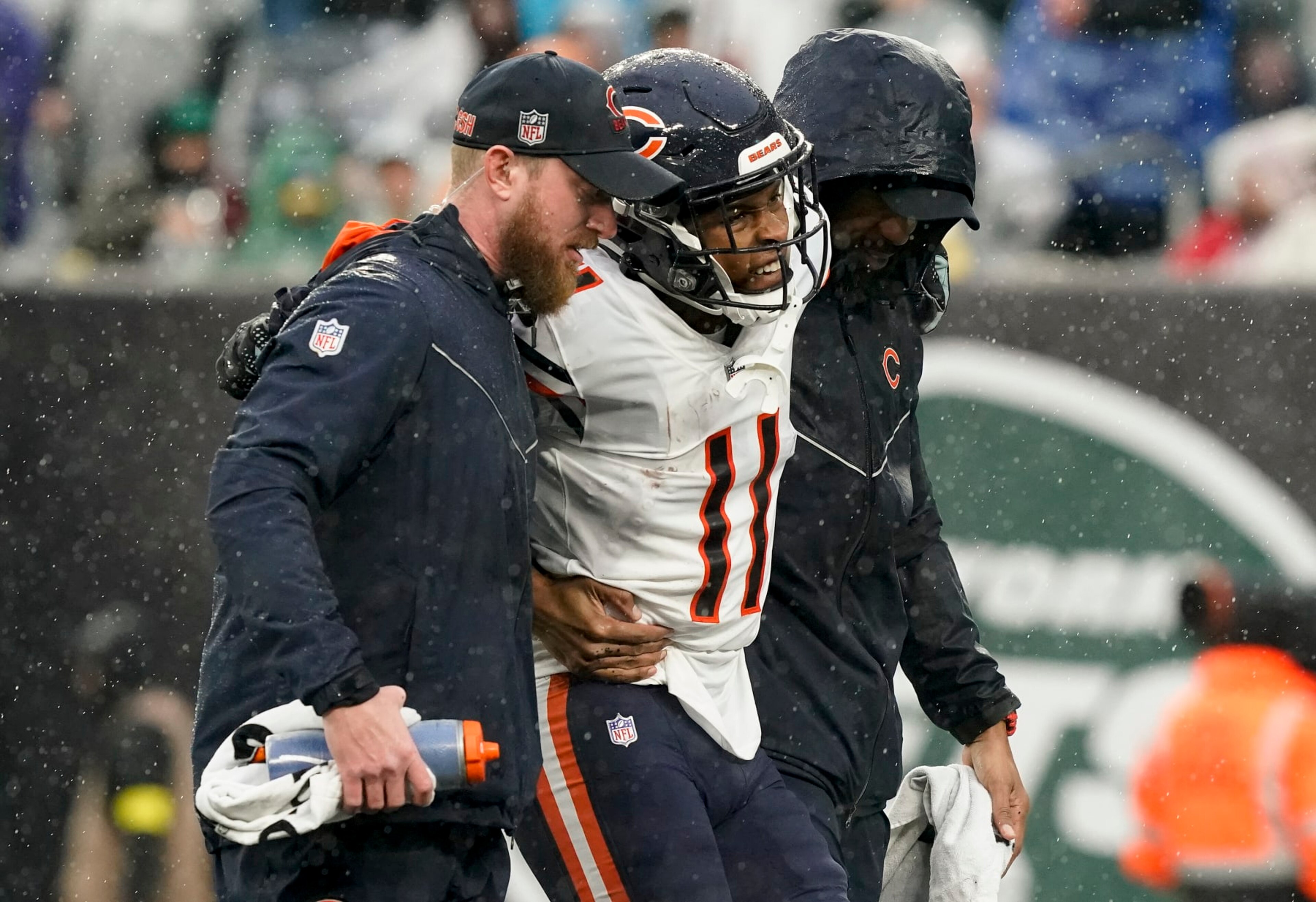 Chicago Bears wide receiver Darnell Mooney (11) is helped off the field during the third quarter of an NFL football game against the New York Jets , Sunday, Nov. 27, 2022, in East Rutherford, N.J. (AP Photo/John Minchillo)