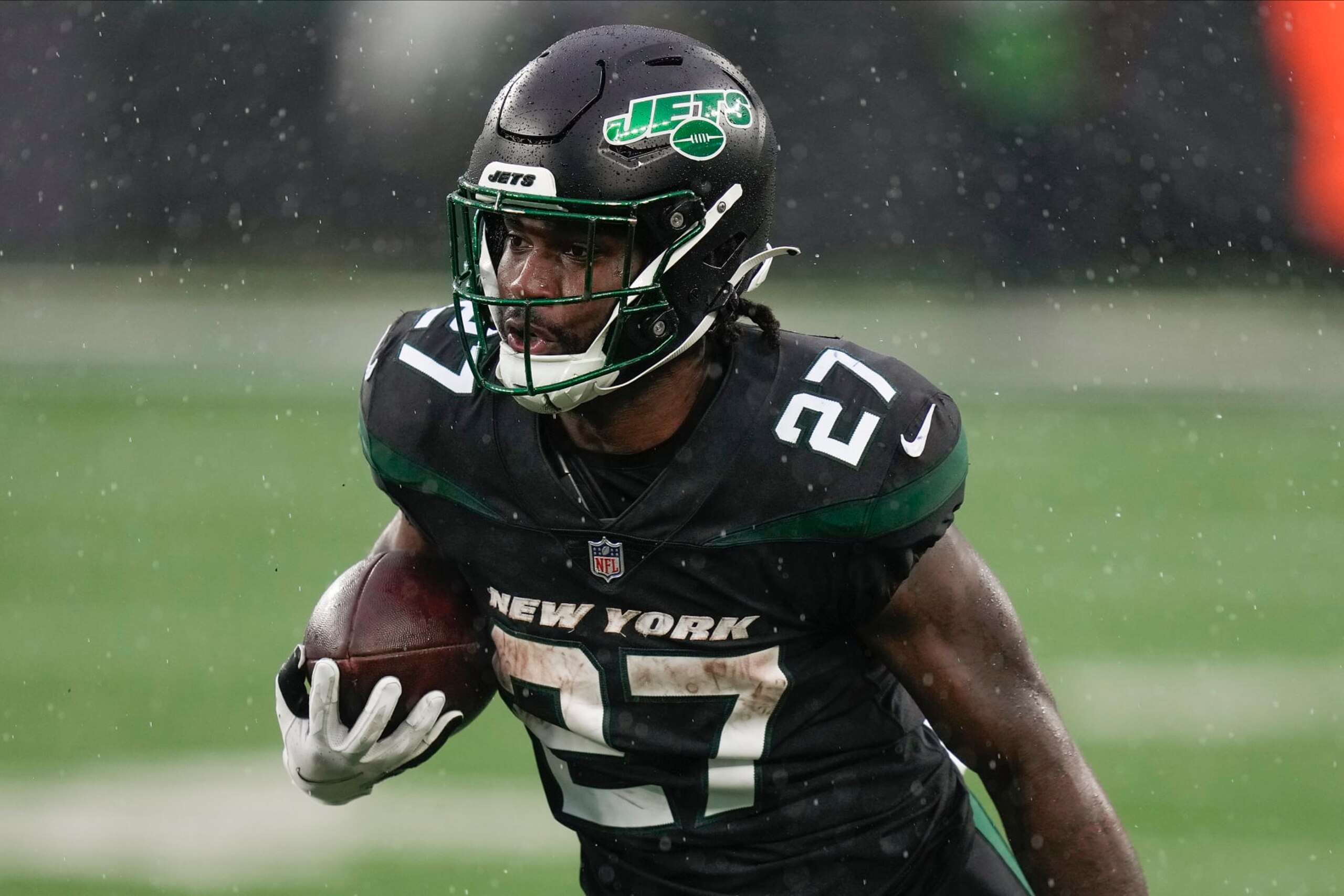New York Jets running back Zonovan Knight (27) carries the ball against the Chicago Bears during the third quarter of an NFL football game, Sunday, Nov. 27, 2022, in East Rutherford, N.J. (AP Photo/Seth Wenig) New York Jets running back Zonovan Knight (27) carries the ball against the Chicago Bears during the third quarter of an NFL football game, Sunday, Nov. 27, 2022, in East Rutherford, N.J. (AP Photo/Seth Wenig)