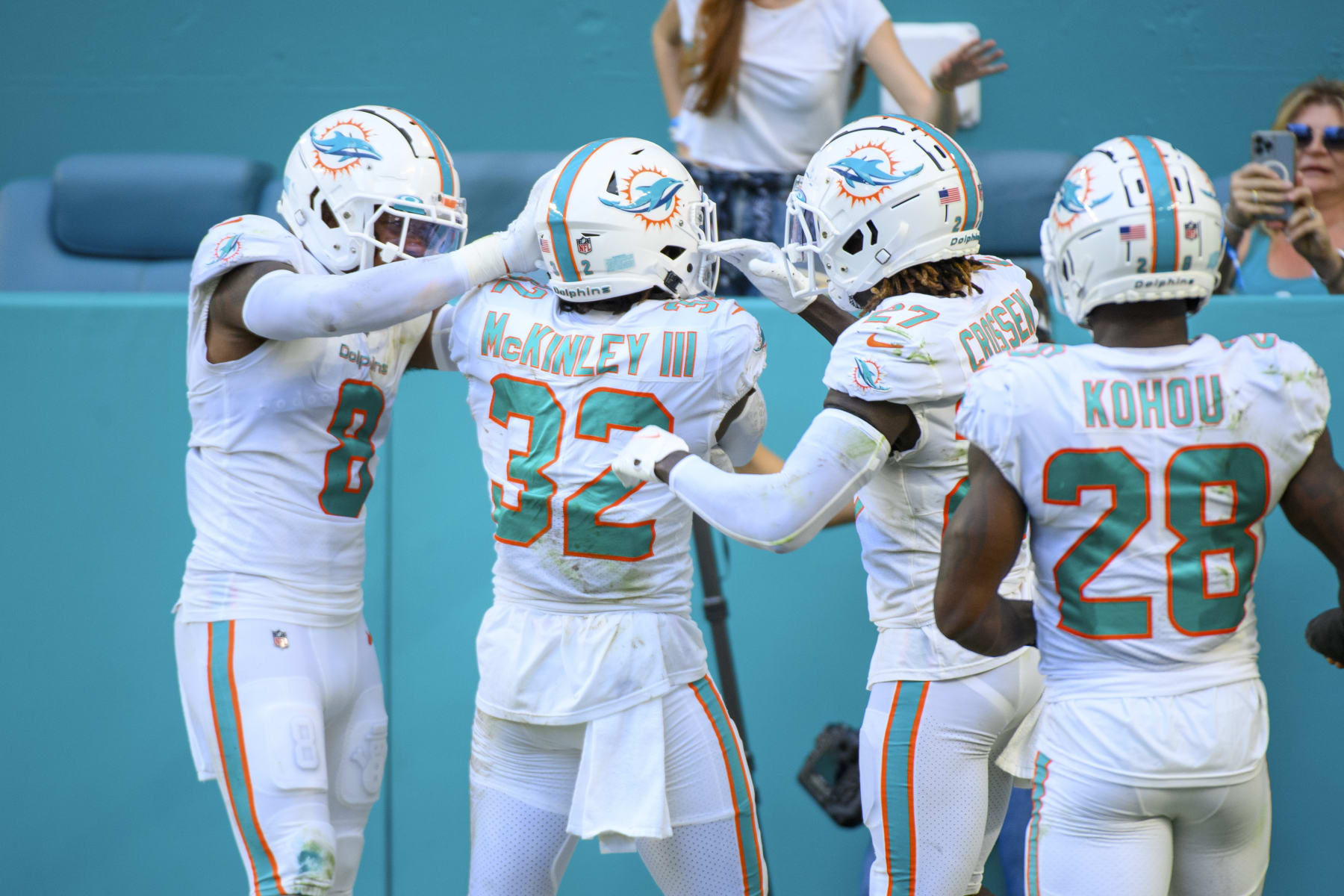 Miami Dolphins safety Verone McKinley III (32) celebrates intercepting a pass from Houston Texans quarterback Kyle Allen (not shown) with Miami Dolphins safety Jevon Holland (8), Miami Dolphins defensive back Keion Crossen (27) and Miami Dolphins cornerback Kader Kohou (28) during an NFL football game between the Houston Texans and the Miami Dolphins, Sunday, Nov. 27, 2022, in Miami Gardens, Fla. (AP Photo/Doug Murray)