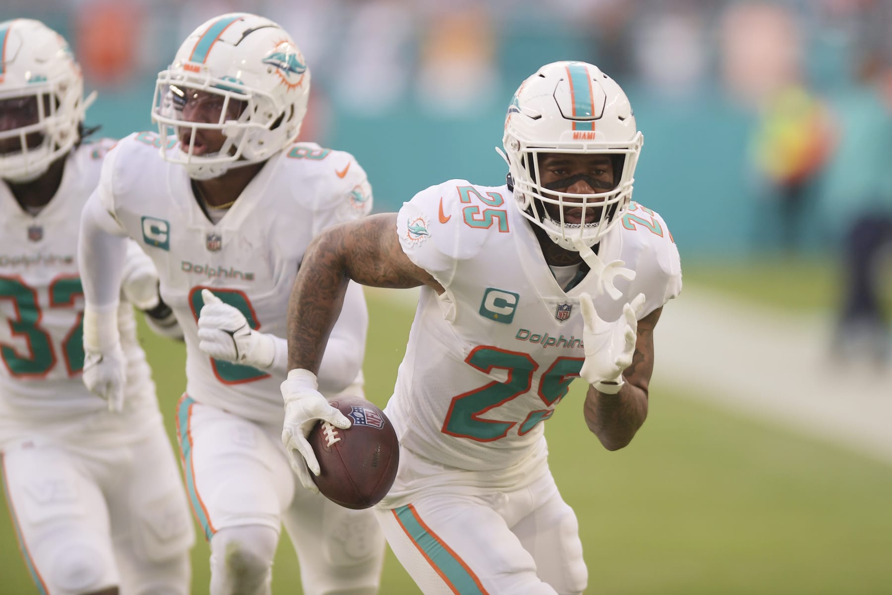 Miami Dolphins cornerback Xavien Howard (25) runs for a touchdown after recovering a fumble by Houston Texans tight end Jordan Akins (88) during the first half of an NFL football game, Sunday, Nov. 27, 2022, in Miami Gardens, Fla. (AP Photo/Michael Laughlin)