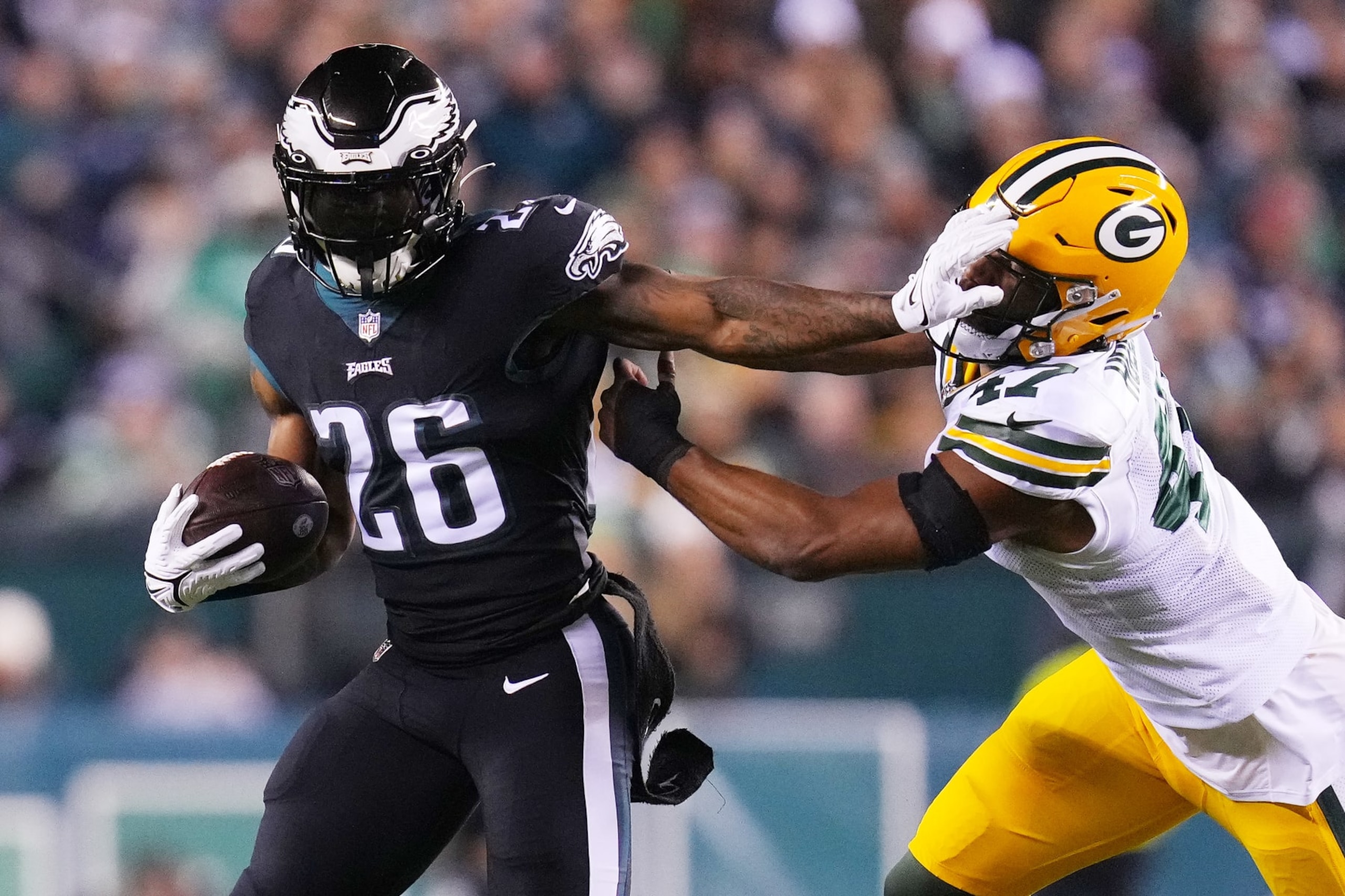 PHILADELPHIA, PENNSYLVANIA - NOVEMBER 27: Miles Sanders #26 of the Philadelphia Eagles stiff arms Justin Hollins #47 of the Green Bay Packers during the first quarter at Lincoln Financial Field on November 27, 2022 in Philadelphia, Pennsylvania. (Photo by Mitchell Leff/Getty Images) PHILADELPHIA, PENNSYLVANIA - NOVEMBER 27: Miles Sanders #26 of the Philadelphia Eagles stiff arms Justin Hollins #47 of the Green Bay Packers during the first quarter at Lincoln Financial Field on November 27, 2022 in Philadelphia, Pennsylvania. (Photo by Mitchell Leff/Getty Images)