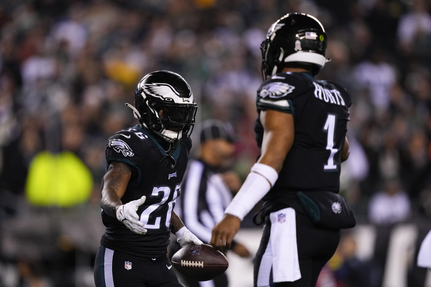 Philadelphia Eagles' Miles Sanders (26) celebrates a touchdown with quarterback Jalen Hurts (1) during the first half of an NFL football game against the Green Bay Packers, Sunday, Nov. 27, 2022, in Philadelphia. (AP Photo/Matt Slocum)