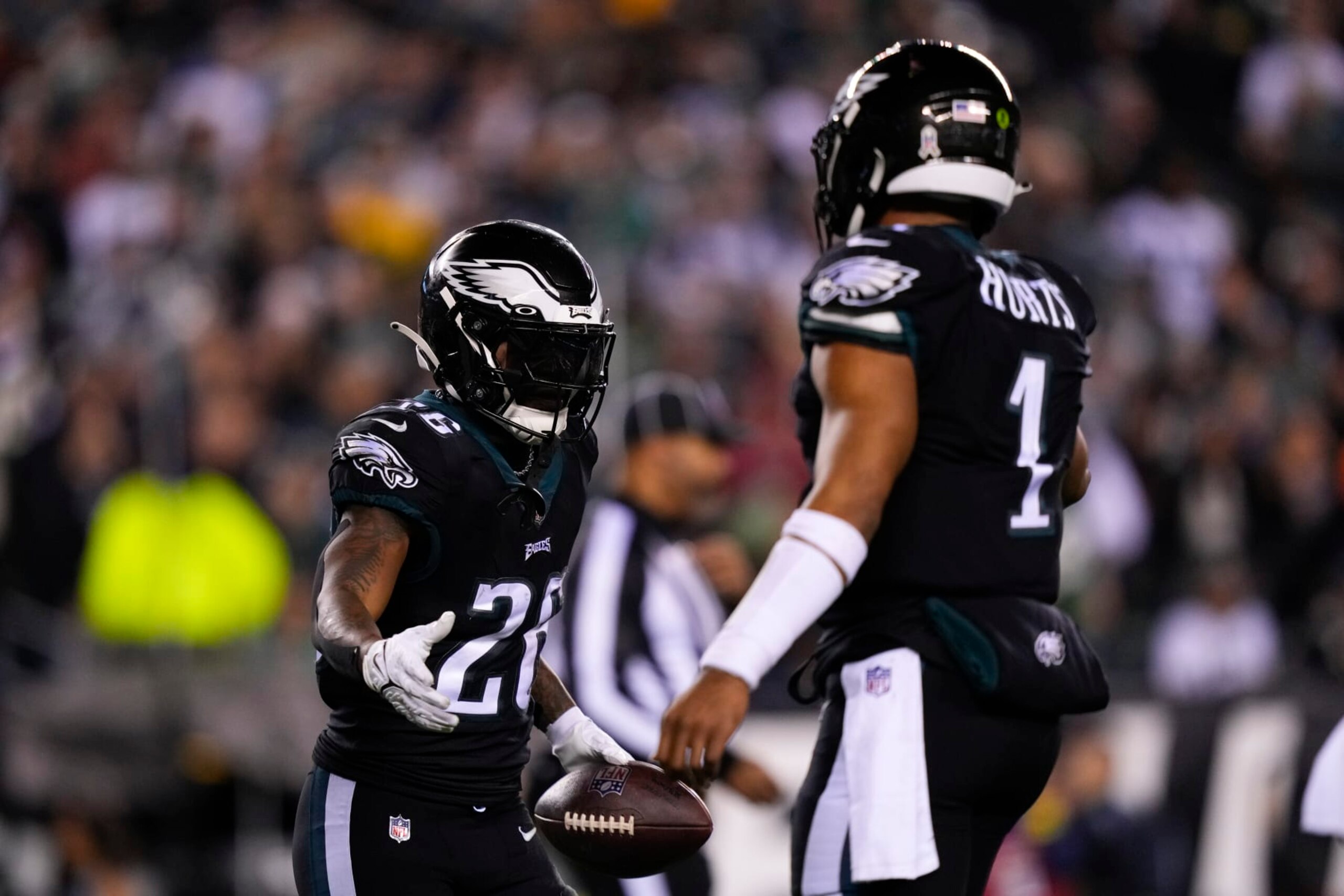 Philadelphia Eagles' Miles Sanders (26) celebrates a touchdown with quarterback Jalen Hurts (1) during the first half of an NFL football game against the Green Bay Packers, Sunday, Nov. 27, 2022, in Philadelphia. (AP Photo/Matt Slocum)