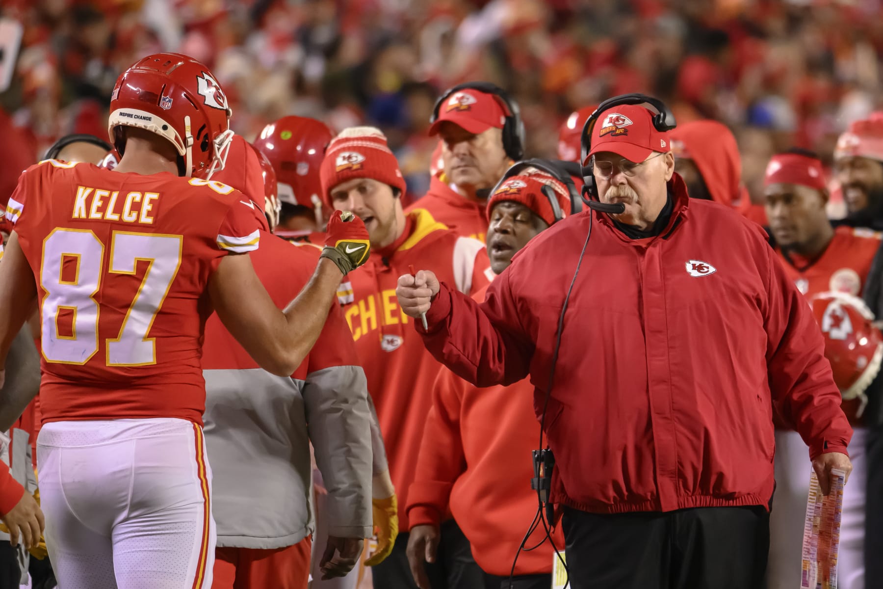 Kansas City Chiefs head coach Andy Reid gives Kansas City Chiefs tight end Travis Kelce (87) a fist bump after a scoring drive during the second half of an NFL football game against the Los Angeles Rams, Sunday, Nov. 27, 2022 in Kansas City, Mo. (AP Photo/Reed Hoffmann)