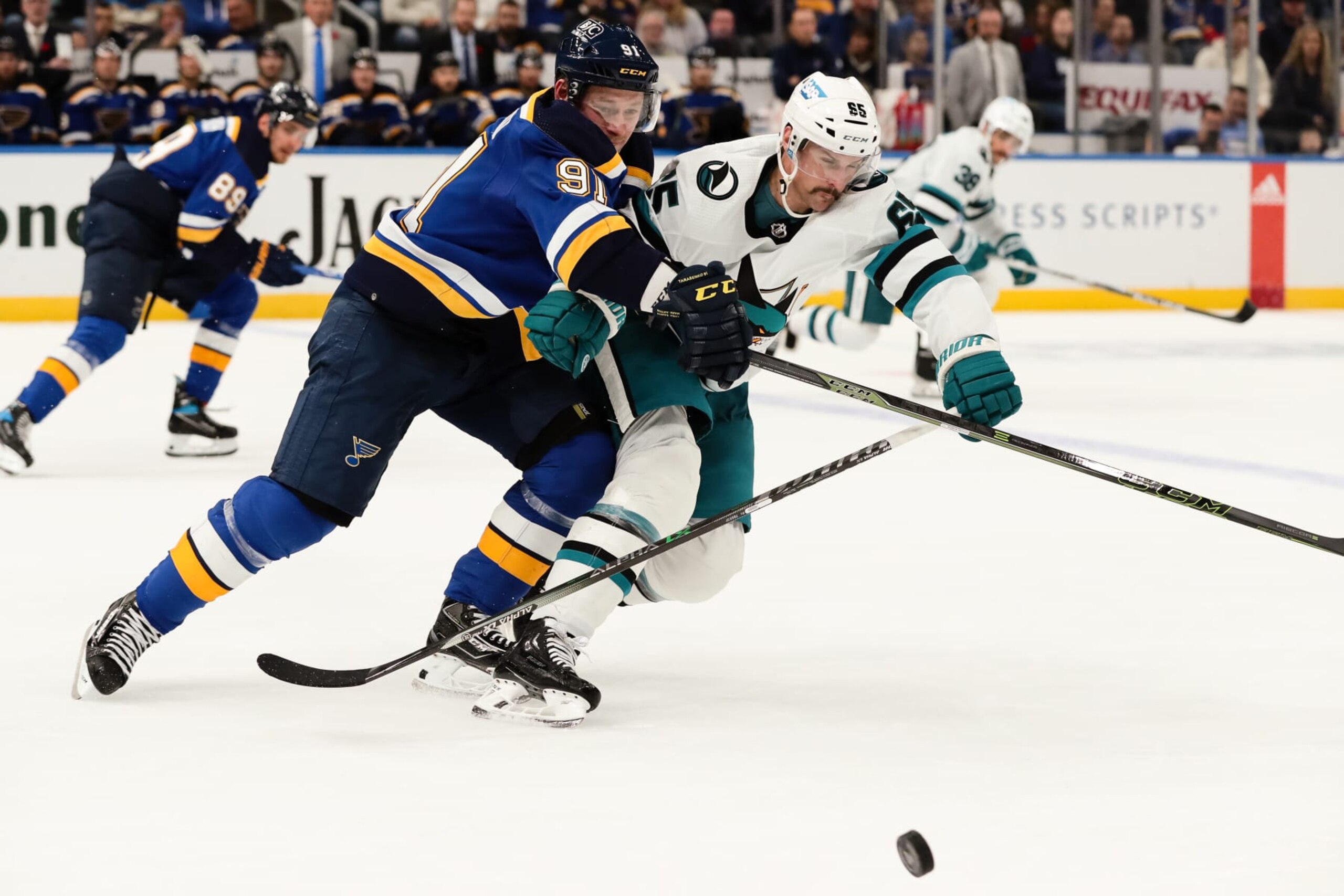 ST. LOUIS, MO - NOVEMBER 10: St. Louis Blues' Vladimir Tarasenko, left, fights for position with San Jose Sharks' Erik Karlsson during the third period of an NHL hockey game between the St. Louis Blues and the San Jose Sharks on November 10, 2022, at the Enterprise Center in St. Louis, MO.  The St. Louis Blues defeated the San Jose Sharks by a score of 5 to 3.      (Photo by Tim Spyers/Icon Sportswire via Getty Images)