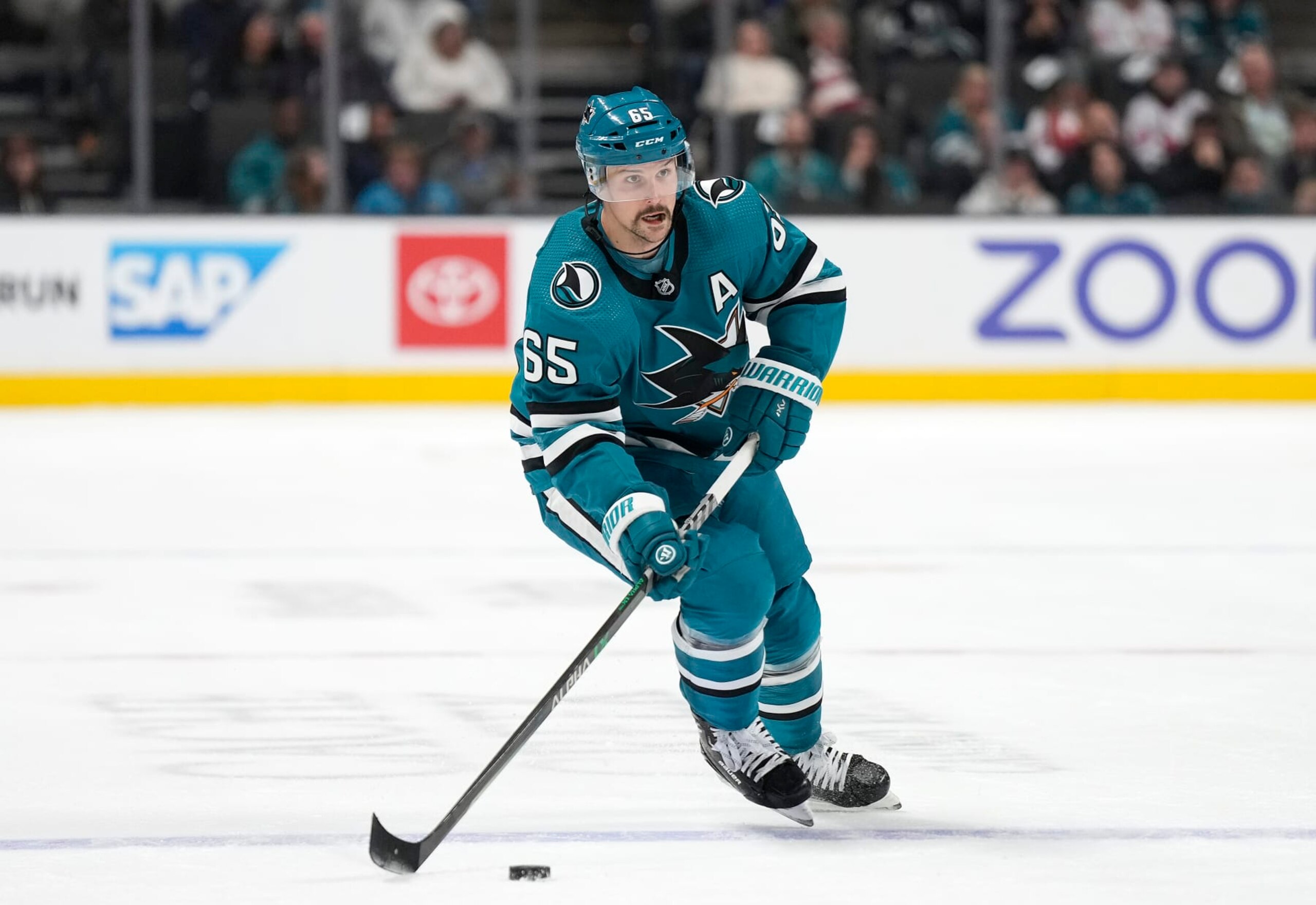 SAN JOSE, CALIFORNIA - NOVEMBER 21: Erik Karlsson #65 of the San Jose Sharks skates with the puck against the Ottawa Senators during the second period of an NHL hockey game at SAP Center on November 21, 2022 in San Jose, California. (Photo by Thearon W. Henderson/Getty Images)