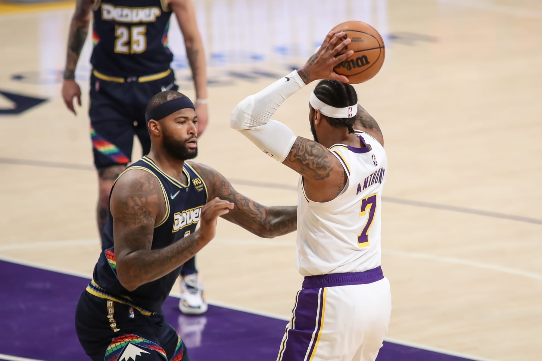 LOS ANGELES, CA - APRIL 03: Los Angeles Lakers forward Carmelo Anthony (7) guarded by Denver Nuggets center DeMarcus Cousins (4) during the Denver Nuggets vs Los Angeles Lakers game on April 03, 2022, at Crypto.com Arena in Los Angeles, CA. (Photo by Jevone Moore/Icon Sportswire via Getty Images)