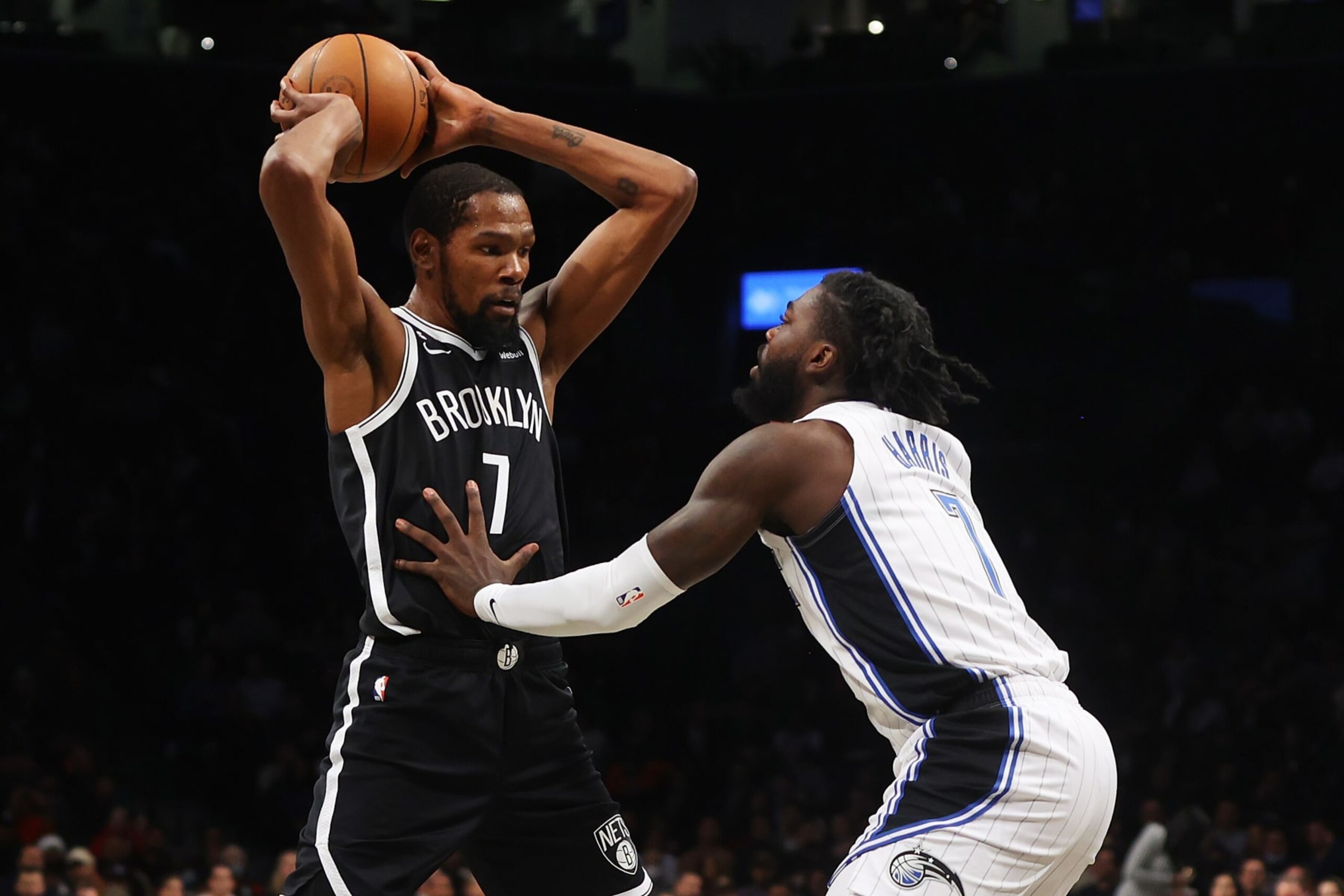 NEW YORK, NEW YORK - NOVEMBER 28: Kevin Durant #7 of the Brooklyn Nets keeps the ball from Kevon Harris #7 of the Orlando Magic in the first half at Barclays Center on November 28, 2022 in New York City. NOTE TO USER: User expressly acknowledges and agrees that, by downloading and or using this photograph, User is consenting to the terms and conditions of the Getty Images License Agreement. (Photo by Mike Stobe/Getty Images) NEW YORK, NEW YORK - NOVEMBER 28: Kevin Durant #7 of the Brooklyn Nets keeps the ball from Kevon Harris #7 of the Orlando Magic in the first half at Barclays Center on November 28, 2022 in New York City. NOTE TO USER: User expressly acknowledges and agrees that, by downloading and or using this photograph, User is consenting to the terms and conditions of the Getty Images License Agreement. (Photo by Mike Stobe/Getty Images)