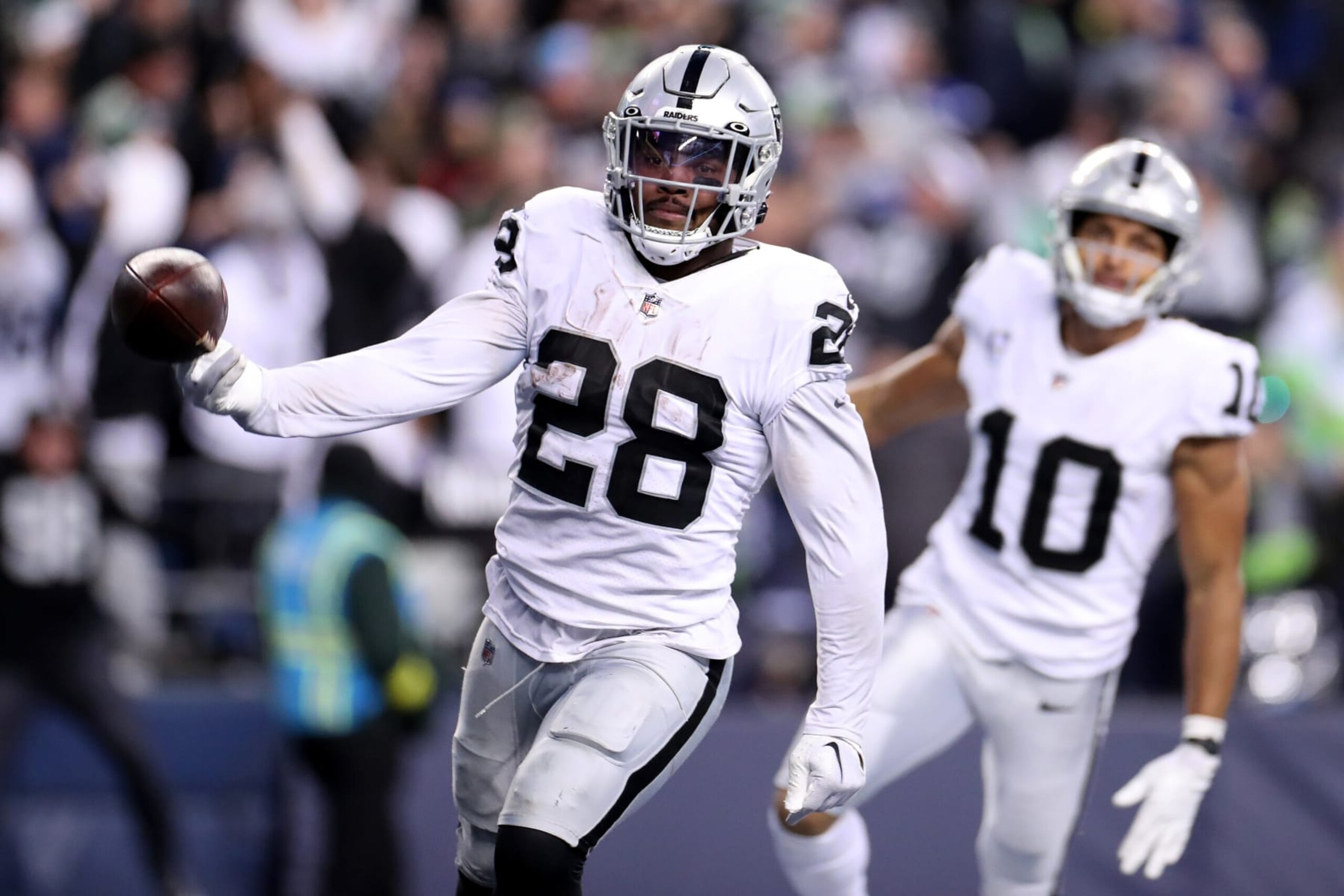 SEATTLE, WASHINGTON - NOVEMBER 27: Josh Jacobs #28 of the Las Vegas Raiders carries the ball for a touchdown in overtime to beat the Seattle Seahawks 40-34 at Lumen Field on November 27, 2022 in Seattle, Washington. (Photo by Steph Chambers/Getty Images) SEATTLE, WASHINGTON - NOVEMBER 27: Josh Jacobs #28 of the Las Vegas Raiders carries the ball for a touchdown in overtime to beat the Seattle Seahawks 40-34 at Lumen Field on November 27, 2022 in Seattle, Washington. (Photo by Steph Chambers/Getty Images)
