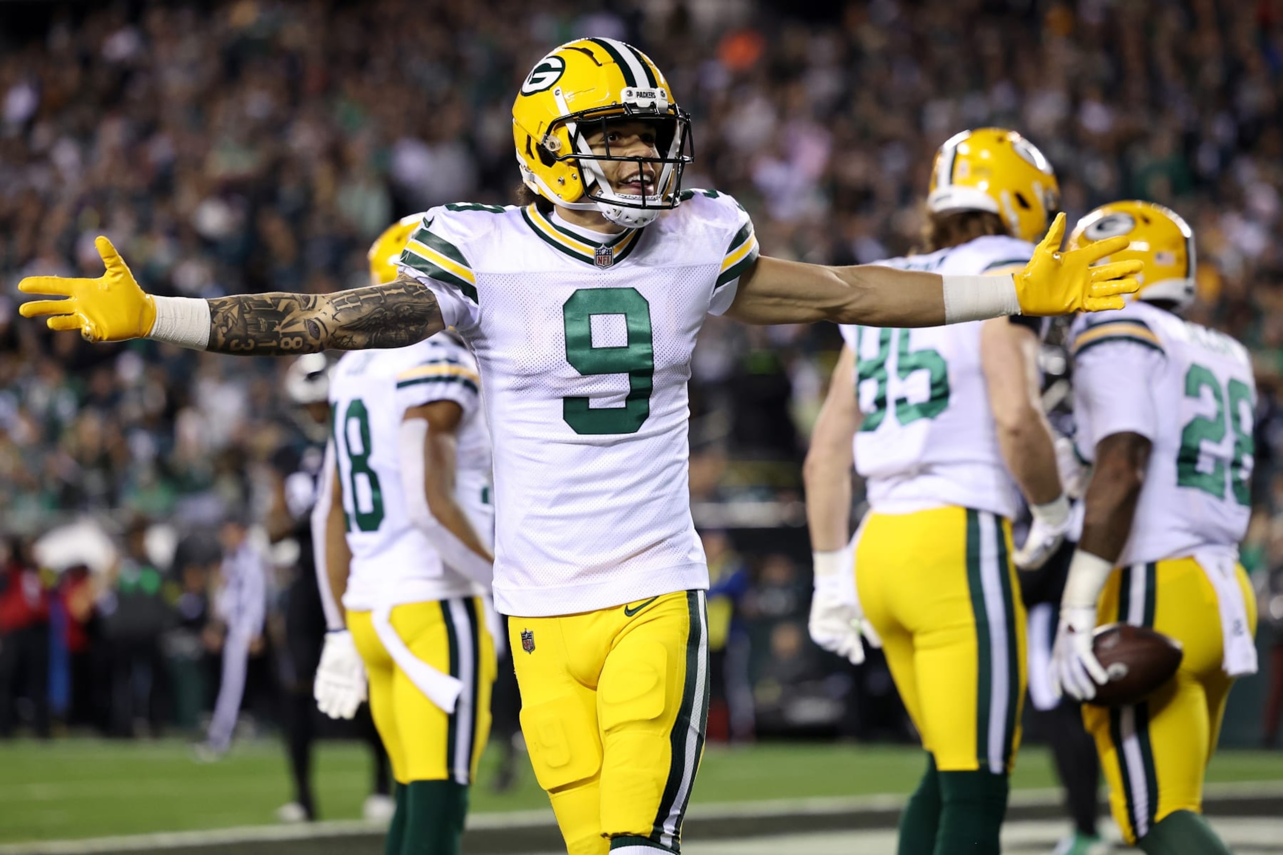 PHILADELPHIA, PENNSYLVANIA - NOVEMBER 27: Christian Watson #9 of the Green Bay Packers celebrates after a rushing touchdown by AJ Dillon #28 during the first quarter against the Philadelphia Eagles at Lincoln Financial Field on November 27, 2022 in Philadelphia, Pennsylvania. (Photo by Scott Taetsch/Getty Images)