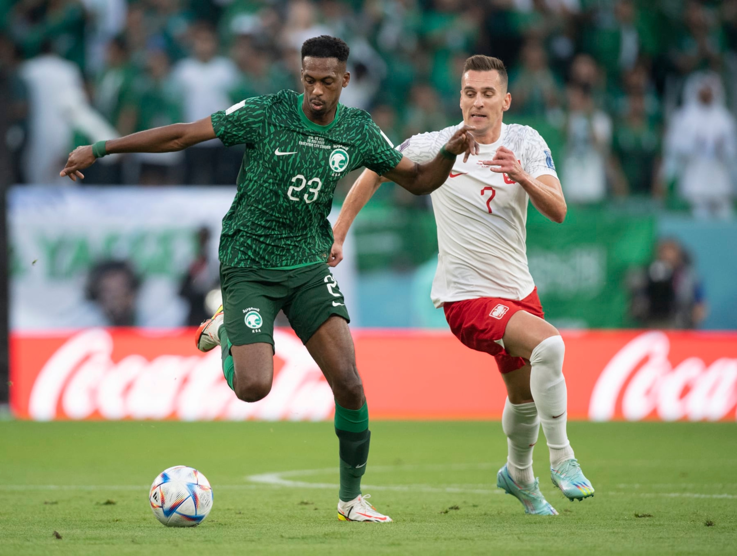 AL RAYYAN, QATAR - NOVEMBER 26: Arkadiusz Milik of Poland and Mohamed Kanno of Saudi Arabia in action during the FIFA World Cup Qatar 2022 Group C match between Poland and Saudi Arabia at Education City Stadium on November 26, 2022 in Al Rayyan, Qatar. (Photo by Visionhaus/Getty Images)
