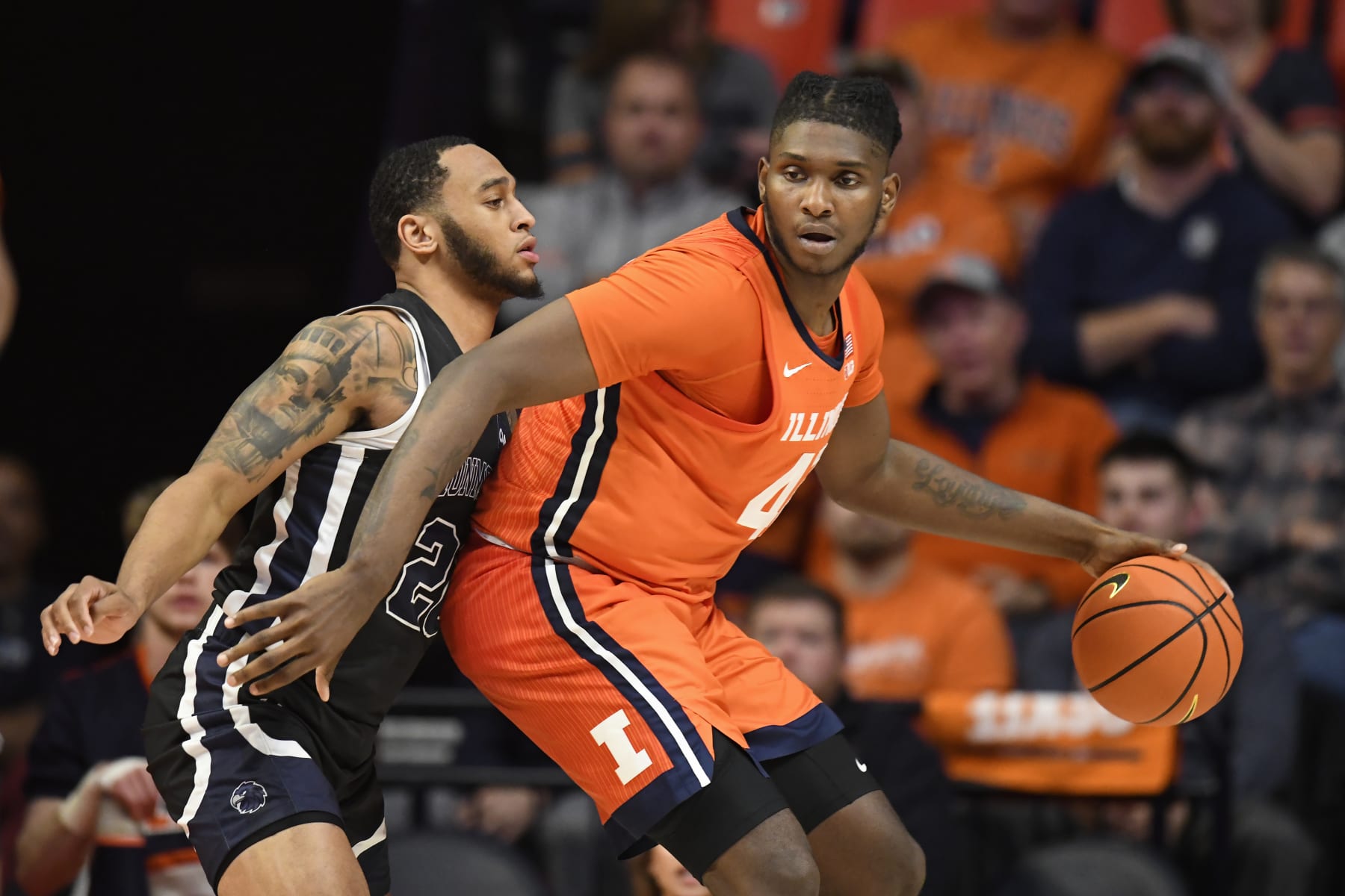 Illinois' Dain Dainja (42) works the ball inside against Monmouth's Tahron Allen during the second half of an NCAA college basketball game, Monday, Nov. 14, 2022, in Champaign, Ill. (AP Photo/Michael Allio)