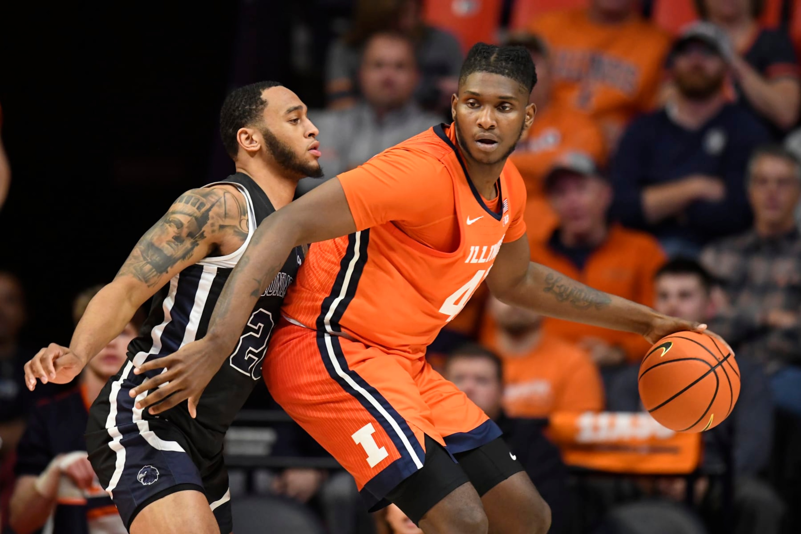 Illinois' Dain Dainja (42) works the ball inside against Monmouth's Tahron Allen during the second half of an NCAA college basketball game, Monday, Nov. 14, 2022, in Champaign, Ill. (AP Photo/Michael Allio)