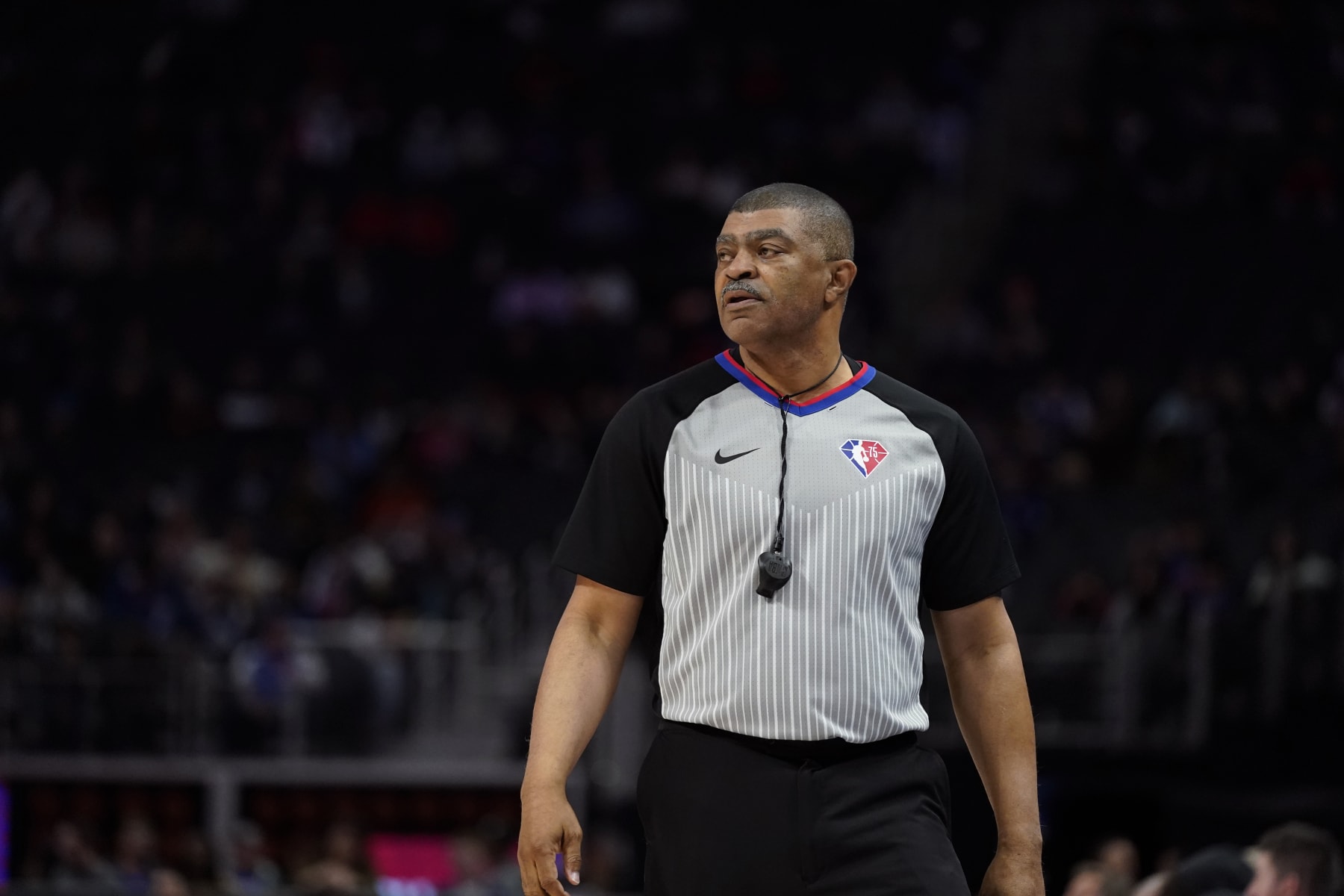 Referee Tony Brothers observes during the first half of an NBA basketball game between the Detroit Pistons and the Washington Wizards, Friday, March 25, 2022, in Detroit. (AP Photo/Carlos Osorio)